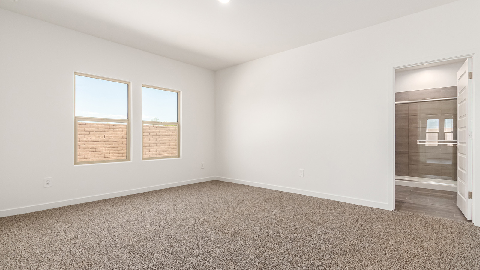 Explore The Baxter at The Oasis at Rocking K in Vail, Arizona, a meticulously designed single-story new home floorplan offering 1,423 square feet of beautifully appointed living space.  As you step inside, you'll immediately appreciate the open and inviting layout that seamlessly connects the great room, dining area, and kitchen. The heart of the home, the kitchen, is equipped with sleek stainless-steel appliances, including a built-in microwave and gas range. The central island with a breakfast bar serves as a gathering spot for casual meals and entertaining.  The adjacent dining room flows effortlessly into a covered patio, perfect for extending your living space outdoors. The great room, with its large windows, allows natural light to flood the space, creating a warm and welcoming atmosphere.  The primary suite is a private hideaway, featuring a spacious walk-in closet and an en-suite bathroom. Two additional bedrooms are located near the front of the home, offering ample space and privacy for family members or guests. These rooms share a well-appointed full bathroom.  Additional standard features of The Baxter include energy-efficient dual-pane windows, a tankless water heater, and smart home technology that allows you to control the thermostat, lighting, and security system from your smartphone. The home also comes with a fully landscaped front yard with automatic drip irrigation, ensuring your home looks beautiful with minimal effort.  The two-car garage, utility room with washer/dryer hookups, and abundant storage throughout the home make the Baxter not only stylish but incredibly functional, catering to the needs of modern living.  The Baxter at The Oasis at Rocking K is where thoughtful design meets convenience, making it the perfect home for those seeking a blend of comfort, style, and functionality.