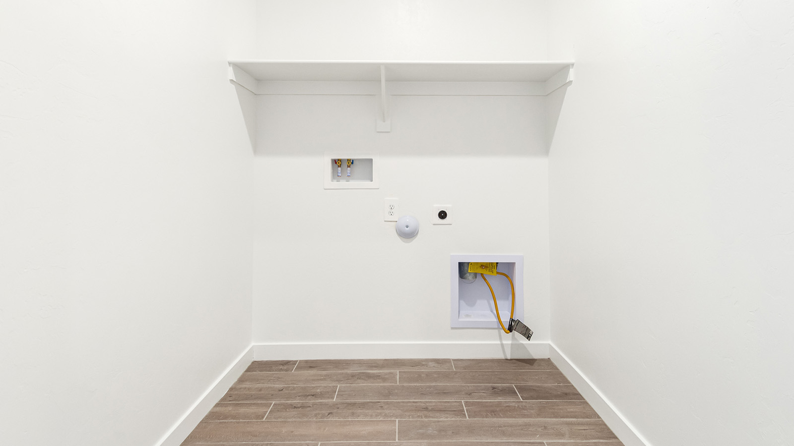 Explore The Baxter at The Oasis at Rocking K in Vail, Arizona, a meticulously designed single-story new home floorplan offering 1,423 square feet of beautifully appointed living space.  As you step inside, you'll immediately appreciate the open and inviting layout that seamlessly connects the great room, dining area, and kitchen. The heart of the home, the kitchen, is equipped with sleek stainless-steel appliances, including a built-in microwave and gas range. The central island with a breakfast bar serves as a gathering spot for casual meals and entertaining.  The adjacent dining room flows effortlessly into a covered patio, perfect for extending your living space outdoors. The great room, with its large windows, allows natural light to flood the space, creating a warm and welcoming atmosphere.  The primary suite is a private hideaway, featuring a spacious walk-in closet and an en-suite bathroom. Two additional bedrooms are located near the front of the home, offering ample space and privacy for family members or guests. These rooms share a well-appointed full bathroom.  Additional standard features of The Baxter include energy-efficient dual-pane windows, a tankless water heater, and smart home technology that allows you to control the thermostat, lighting, and security system from your smartphone. The home also comes with a fully landscaped front yard with automatic drip irrigation, ensuring your home looks beautiful with minimal effort.  The two-car garage, utility room with washer/dryer hookups, and abundant storage throughout the home make the Baxter not only stylish but incredibly functional, catering to the needs of modern living.  The Baxter at The Oasis at Rocking K is where thoughtful design meets convenience, making it the perfect home for those seeking a blend of comfort, style, and functionality.