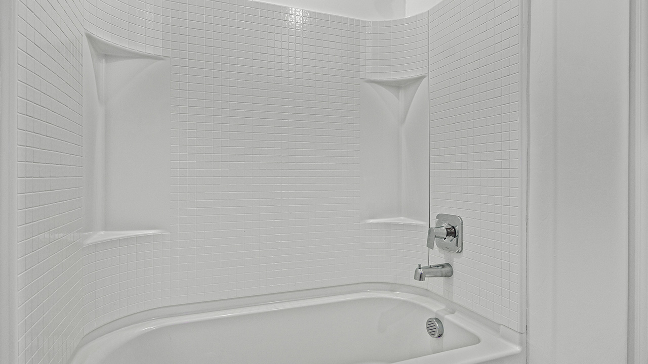 Explore The Baxter at The Oasis at Rocking K in Vail, Arizona, a meticulously designed single-story new home floorplan offering 1,423 square feet of beautifully appointed living space.  As you step inside, you'll immediately appreciate the open and inviting layout that seamlessly connects the great room, dining area, and kitchen. The heart of the home, the kitchen, is equipped with sleek stainless-steel appliances, including a built-in microwave and gas range. The central island with a breakfast bar serves as a gathering spot for casual meals and entertaining.  The adjacent dining room flows effortlessly into a covered patio, perfect for extending your living space outdoors. The great room, with its large windows, allows natural light to flood the space, creating a warm and welcoming atmosphere.  The primary suite is a private hideaway, featuring a spacious walk-in closet and an en-suite bathroom. Two additional bedrooms are located near the front of the home, offering ample space and privacy for family members or guests. These rooms share a well-appointed full bathroom.  Additional standard features of The Baxter include energy-efficient dual-pane windows, a tankless water heater, and smart home technology that allows you to control the thermostat, lighting, and security system from your smartphone. The home also comes with a fully landscaped front yard with automatic drip irrigation, ensuring your home looks beautiful with minimal effort.  The two-car garage, utility room with washer/dryer hookups, and abundant storage throughout the home make the Baxter not only stylish but incredibly functional, catering to the needs of modern living.  The Baxter at The Oasis at Rocking K is where thoughtful design meets convenience, making it the perfect home for those seeking a blend of comfort, style, and functionality.