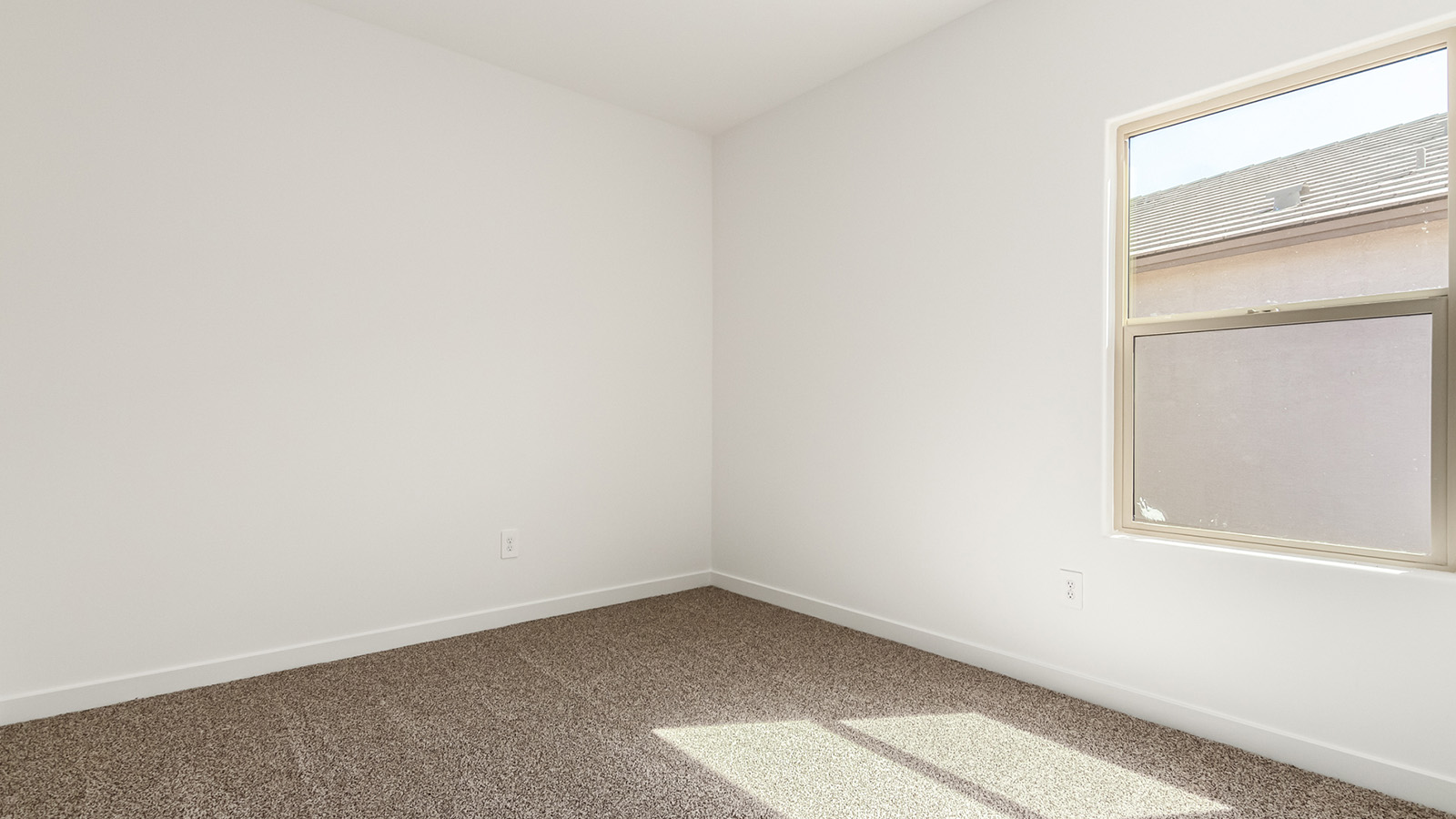 Explore The Baxter at The Oasis at Rocking K in Vail, Arizona, a meticulously designed single-story new home floorplan offering 1,423 square feet of beautifully appointed living space.  As you step inside, you'll immediately appreciate the open and inviting layout that seamlessly connects the great room, dining area, and kitchen. The heart of the home, the kitchen, is equipped with sleek stainless-steel appliances, including a built-in microwave and gas range. The central island with a breakfast bar serves as a gathering spot for casual meals and entertaining.  The adjacent dining room flows effortlessly into a covered patio, perfect for extending your living space outdoors. The great room, with its large windows, allows natural light to flood the space, creating a warm and welcoming atmosphere.  The primary suite is a private hideaway, featuring a spacious walk-in closet and an en-suite bathroom. Two additional bedrooms are located near the front of the home, offering ample space and privacy for family members or guests. These rooms share a well-appointed full bathroom.  Additional standard features of The Baxter include energy-efficient dual-pane windows, a tankless water heater, and smart home technology that allows you to control the thermostat, lighting, and security system from your smartphone. The home also comes with a fully landscaped front yard with automatic drip irrigation, ensuring your home looks beautiful with minimal effort.  The two-car garage, utility room with washer/dryer hookups, and abundant storage throughout the home make the Baxter not only stylish but incredibly functional, catering to the needs of modern living.  The Baxter at The Oasis at Rocking K is where thoughtful design meets convenience, making it the perfect home for those seeking a blend of comfort, style, and functionality.