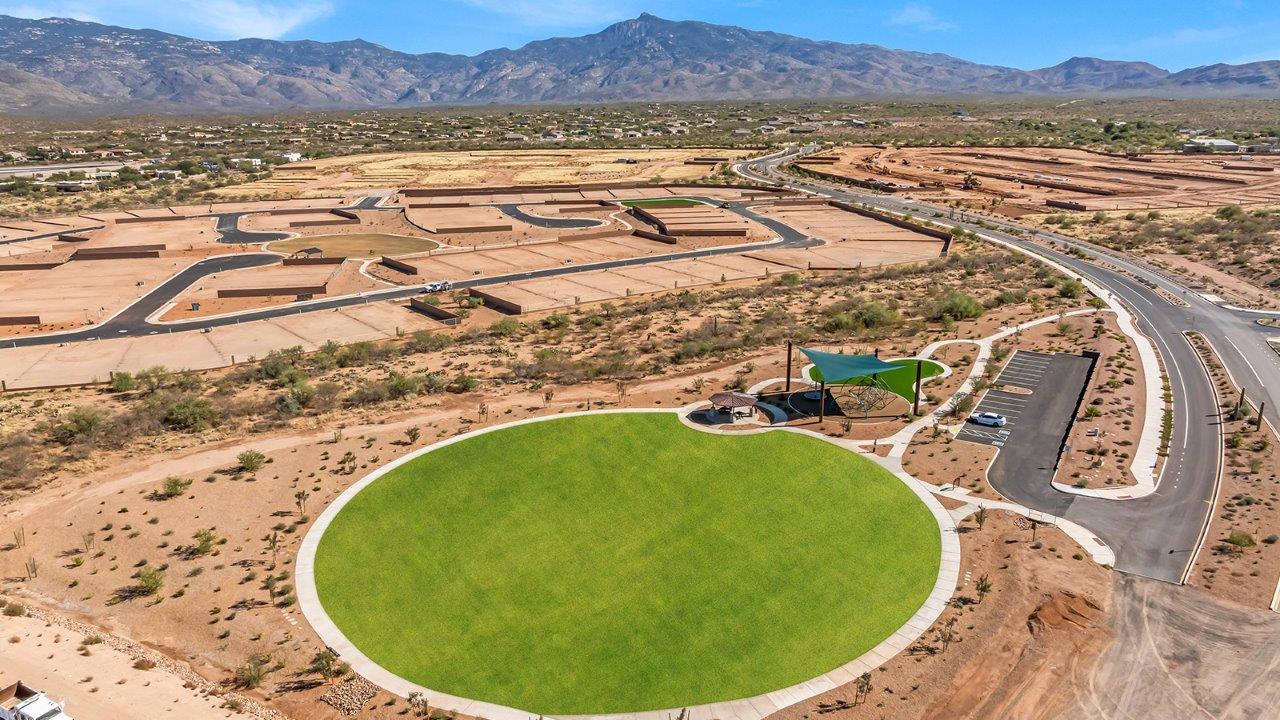 Explore The Baxter at The Oasis at Rocking K in Vail, Arizona, a meticulously designed single-story new home floorplan offering 1,423 square feet of beautifully appointed living space.  As you step inside, you'll immediately appreciate the open and inviting layout that seamlessly connects the great room, dining area, and kitchen. The heart of the home, the kitchen, is equipped with sleek stainless-steel appliances, including a built-in microwave and gas range. The central island with a breakfast bar serves as a gathering spot for casual meals and entertaining.  The adjacent dining room flows effortlessly into a covered patio, perfect for extending your living space outdoors. The great room, with its large windows, allows natural light to flood the space, creating a warm and welcoming atmosphere.  The primary suite is a private hideaway, featuring a spacious walk-in closet and an en-suite bathroom. Two additional bedrooms are located near the front of the home, offering ample space and privacy for family members or guests. These rooms share a well-appointed full bathroom.  Additional standard features of The Baxter include energy-efficient dual-pane windows, a tankless water heater, and smart home technology that allows you to control the thermostat, lighting, and security system from your smartphone. The home also comes with a fully landscaped front yard with automatic drip irrigation, ensuring your home looks beautiful with minimal effort.  The two-car garage, utility room with washer/dryer hookups, and abundant storage throughout the home make the Baxter not only stylish but incredibly functional, catering to the needs of modern living.  The Baxter at The Oasis at Rocking K is where thoughtful design meets convenience, making it the perfect home for those seeking a blend of comfort, style, and functionality.