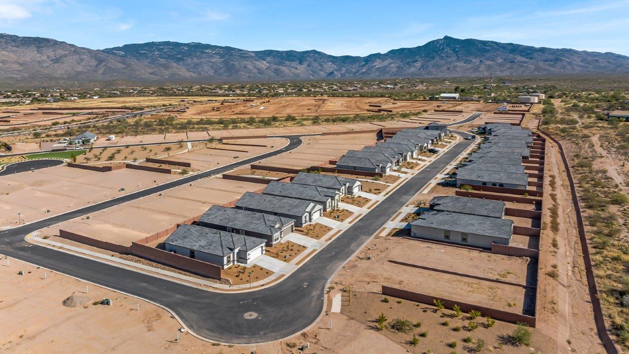 Explore The Baxter at The Oasis at Rocking K in Vail, Arizona, a meticulously designed single-story new home floorplan offering 1,423 square feet of beautifully appointed living space.  As you step inside, you'll immediately appreciate the open and inviting layout that seamlessly connects the great room, dining area, and kitchen. The heart of the home, the kitchen, is equipped with sleek stainless-steel appliances, including a built-in microwave and gas range. The central island with a breakfast bar serves as a gathering spot for casual meals and entertaining.  The adjacent dining room flows effortlessly into a covered patio, perfect for extending your living space outdoors. The great room, with its large windows, allows natural light to flood the space, creating a warm and welcoming atmosphere.  The primary suite is a private hideaway, featuring a spacious walk-in closet and an en-suite bathroom. Two additional bedrooms are located near the front of the home, offering ample space and privacy for family members or guests. These rooms share a well-appointed full bathroom.  Additional standard features of The Baxter include energy-efficient dual-pane windows, a tankless water heater, and smart home technology that allows you to control the thermostat, lighting, and security system from your smartphone. The home also comes with a fully landscaped front yard with automatic drip irrigation, ensuring your home looks beautiful with minimal effort.  The two-car garage, utility room with washer/dryer hookups, and abundant storage throughout the home make the Baxter not only stylish but incredibly functional, catering to the needs of modern living.  The Baxter at The Oasis at Rocking K is where thoughtful design meets convenience, making it the perfect home for those seeking a blend of comfort, style, and functionality.