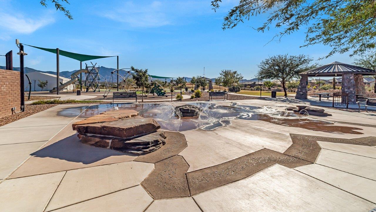 Explore The Baxter at The Oasis at Rocking K in Vail, Arizona, a meticulously designed single-story new home floorplan offering 1,423 square feet of beautifully appointed living space.  As you step inside, you'll immediately appreciate the open and inviting layout that seamlessly connects the great room, dining area, and kitchen. The heart of the home, the kitchen, is equipped with sleek stainless-steel appliances, including a built-in microwave and gas range. The central island with a breakfast bar serves as a gathering spot for casual meals and entertaining.  The adjacent dining room flows effortlessly into a covered patio, perfect for extending your living space outdoors. The great room, with its large windows, allows natural light to flood the space, creating a warm and welcoming atmosphere.  The primary suite is a private hideaway, featuring a spacious walk-in closet and an en-suite bathroom. Two additional bedrooms are located near the front of the home, offering ample space and privacy for family members or guests. These rooms share a well-appointed full bathroom.  Additional standard features of The Baxter include energy-efficient dual-pane windows, a tankless water heater, and smart home technology that allows you to control the thermostat, lighting, and security system from your smartphone. The home also comes with a fully landscaped front yard with automatic drip irrigation, ensuring your home looks beautiful with minimal effort.  The two-car garage, utility room with washer/dryer hookups, and abundant storage throughout the home make the Baxter not only stylish but incredibly functional, catering to the needs of modern living.  The Baxter at The Oasis at Rocking K is where thoughtful design meets convenience, making it the perfect home for those seeking a blend of comfort, style, and functionality.