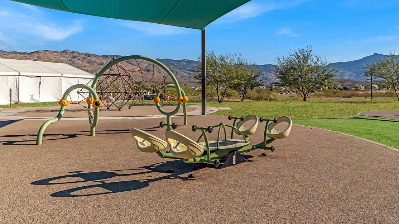 Explore The Baxter at The Oasis at Rocking K in Vail, Arizona, a meticulously designed single-story new home floorplan offering 1,423 square feet of beautifully appointed living space.  As you step inside, you'll immediately appreciate the open and inviting layout that seamlessly connects the great room, dining area, and kitchen. The heart of the home, the kitchen, is equipped with sleek stainless-steel appliances, including a built-in microwave and gas range. The central island with a breakfast bar serves as a gathering spot for casual meals and entertaining.  The adjacent dining room flows effortlessly into a covered patio, perfect for extending your living space outdoors. The great room, with its large windows, allows natural light to flood the space, creating a warm and welcoming atmosphere.  The primary suite is a private hideaway, featuring a spacious walk-in closet and an en-suite bathroom. Two additional bedrooms are located near the front of the home, offering ample space and privacy for family members or guests. These rooms share a well-appointed full bathroom.  Additional standard features of The Baxter include energy-efficient dual-pane windows, a tankless water heater, and smart home technology that allows you to control the thermostat, lighting, and security system from your smartphone. The home also comes with a fully landscaped front yard with automatic drip irrigation, ensuring your home looks beautiful with minimal effort.  The two-car garage, utility room with washer/dryer hookups, and abundant storage throughout the home make the Baxter not only stylish but incredibly functional, catering to the needs of modern living.  The Baxter at The Oasis at Rocking K is where thoughtful design meets convenience, making it the perfect home for those seeking a blend of comfort, style, and functionality.