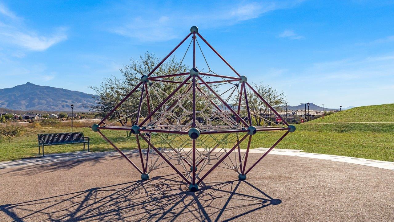 Explore The Baxter at The Oasis at Rocking K in Vail, Arizona, a meticulously designed single-story new home floorplan offering 1,423 square feet of beautifully appointed living space.  As you step inside, you'll immediately appreciate the open and inviting layout that seamlessly connects the great room, dining area, and kitchen. The heart of the home, the kitchen, is equipped with sleek stainless-steel appliances, including a built-in microwave and gas range. The central island with a breakfast bar serves as a gathering spot for casual meals and entertaining.  The adjacent dining room flows effortlessly into a covered patio, perfect for extending your living space outdoors. The great room, with its large windows, allows natural light to flood the space, creating a warm and welcoming atmosphere.  The primary suite is a private hideaway, featuring a spacious walk-in closet and an en-suite bathroom. Two additional bedrooms are located near the front of the home, offering ample space and privacy for family members or guests. These rooms share a well-appointed full bathroom.  Additional standard features of The Baxter include energy-efficient dual-pane windows, a tankless water heater, and smart home technology that allows you to control the thermostat, lighting, and security system from your smartphone. The home also comes with a fully landscaped front yard with automatic drip irrigation, ensuring your home looks beautiful with minimal effort.  The two-car garage, utility room with washer/dryer hookups, and abundant storage throughout the home make the Baxter not only stylish but incredibly functional, catering to the needs of modern living.  The Baxter at The Oasis at Rocking K is where thoughtful design meets convenience, making it the perfect home for those seeking a blend of comfort, style, and functionality.