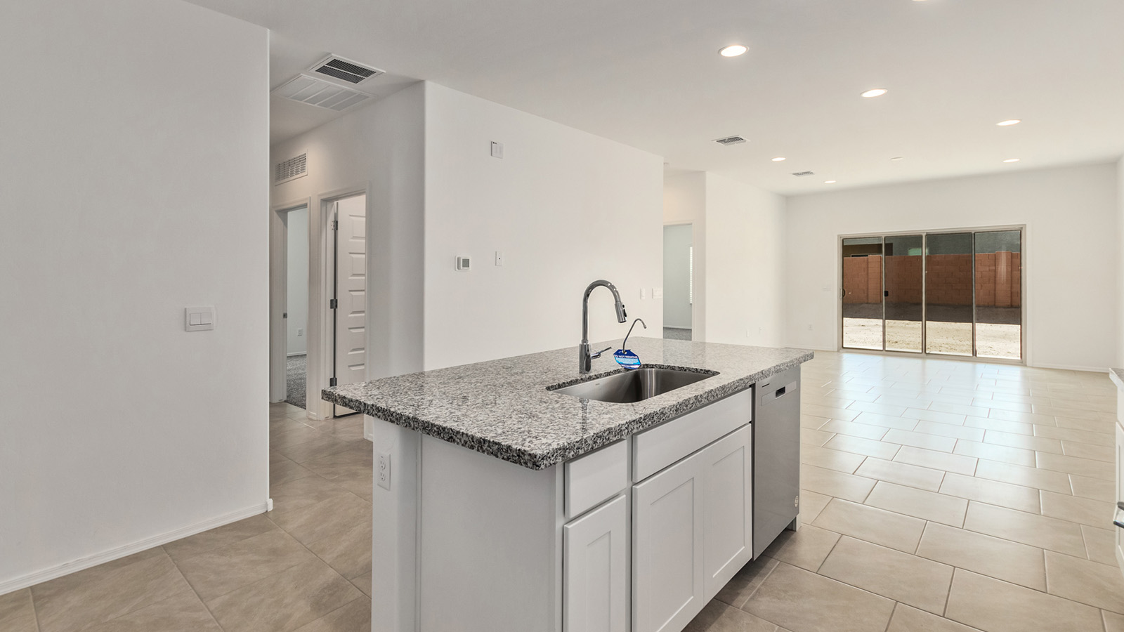 The Dalton at The Oasis at Rocking K presents an exceptional living experience that blends comfort and style within its thoughtfully crafted 1,569 square feet. This one-story, four-bedroom, two-bathroom home is designed to cater to a variety of lifestyle needs, offering both privacy and open spaces that encourage togetherness. As you step into the welcoming entryway, you're led into a spacious great room that seamlessly connects with the dining room and kitchen, creating a perfect setting for daily living and entertaining. The kitchen is a true culinary delight, featuring elegant quartz countertops, 42” shaker-style cabinets, and a modern layout that includes a pantry for additional storage.  The primary suite, located at the rear of the home, serves as a private oasis with a walk-in closet and a luxurious bathroom, complete with dual sinks and high-quality fixtures. The additional three bedrooms are positioned towards the front of the home, providing ample space for family, guests, or a home office setup. Each bedroom is well-proportioned, offering comfort and flexibility in their use.  The Dalton also features a covered patio, ideal for outdoor dining and relaxation, where you can enjoy the breathtaking views and Arizona sunsets that The Oasis at Rocking K is known for. The home includes a two-car garage, providing ample storage and parking space. Additionally, the front yard is meticulously landscaped with auto drip irrigation, ensuring your home’s curb appeal remains pristine year-round.  Living in The Oasis at Rocking K means enjoying a community filled with modern conveniences and natural beauty. Each home, including The Dalton, is equipped with D.R. Horton’s Home is Connected® Smart Home package, ensuring you have the latest in home automation technology. With additional energy-efficient features like spray foam insulation, a tankless water heater, and LED lighting, The Dalton is designed to offer long-term savings and environmental sustainability.  This home isn’t just a place to live; it’s part of a vibrant community where residents can take advantage of amenities such as walking trails, playgrounds, and community events that foster a strong sense of connection among neighbors. The Dalton at The Oasis at Rocking K isn’t just a house—it’s a home where memories are made and a fulfilling lifestyle awaits.