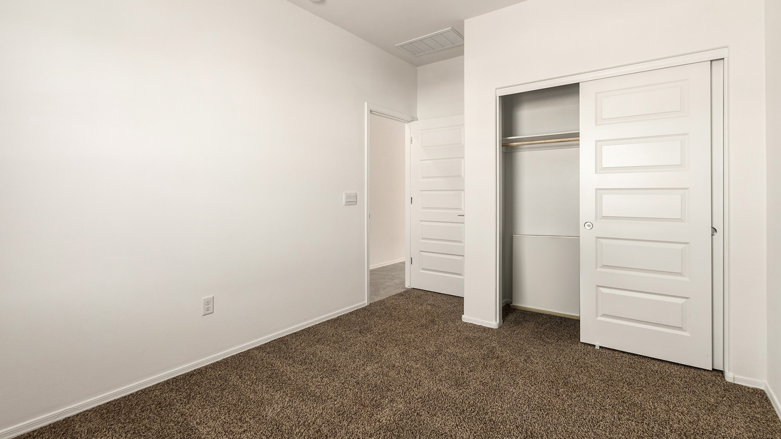 The Dalton at The Oasis at Rocking K presents an exceptional living experience that blends comfort and style within its thoughtfully crafted 1,569 square feet. This one-story, four-bedroom, two-bathroom home is designed to cater to a variety of lifestyle needs, offering both privacy and open spaces that encourage togetherness. As you step into the welcoming entryway, you're led into a spacious great room that seamlessly connects with the dining room and kitchen, creating a perfect setting for daily living and entertaining. The kitchen is a true culinary delight, featuring elegant quartz countertops, 42” shaker-style cabinets, and a modern layout that includes a pantry for additional storage.  The primary suite, located at the rear of the home, serves as a private oasis with a walk-in closet and a luxurious bathroom, complete with dual sinks and high-quality fixtures. The additional three bedrooms are positioned towards the front of the home, providing ample space for family, guests, or a home office setup. Each bedroom is well-proportioned, offering comfort and flexibility in their use.  The Dalton also features a covered patio, ideal for outdoor dining and relaxation, where you can enjoy the breathtaking views and Arizona sunsets that The Oasis at Rocking K is known for. The home includes a two-car garage, providing ample storage and parking space. Additionally, the front yard is meticulously landscaped with auto drip irrigation, ensuring your home’s curb appeal remains pristine year-round.  Living in The Oasis at Rocking K means enjoying a community filled with modern conveniences and natural beauty. Each home, including The Dalton, is equipped with D.R. Horton’s Home is Connected® Smart Home package, ensuring you have the latest in home automation technology. With additional energy-efficient features like spray foam insulation, a tankless water heater, and LED lighting, The Dalton is designed to offer long-term savings and environmental sustainability.  This home isn’t just a place to live; it’s part of a vibrant community where residents can take advantage of amenities such as walking trails, playgrounds, and community events that foster a strong sense of connection among neighbors. The Dalton at The Oasis at Rocking K isn’t just a house—it’s a home where memories are made and a fulfilling lifestyle awaits.