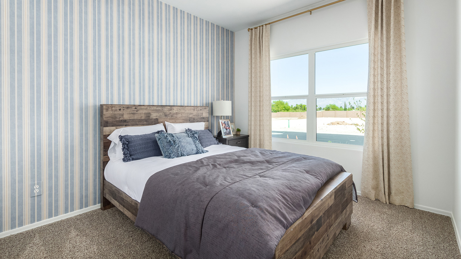 Welcome to The Gaven plan, a spacious single-story new home at The Oasis at Rocking K, where modern living meets the serene beauty of the Arizona landscape. This thoughtfully crafted residence offers 1,815 square feet of well-designed living space, featuring four bedrooms and two full bathrooms, perfect for families who value both comfort and style.  As you step through the front door, you’ll be greeted by a bright and airy entryway that seamlessly transitions into the heart of the home. The open layout connects the great room, dining area, and kitchen, creating an ideal environment for both everyday living and entertaining. The kitchen is a culinary haven, equipped with state-of-the-art appliances, a spacious pantry, and elegant quartz countertops that extend to a large island, perfect for meal prep or casual dining.  The master suite, nestled at the rear of the home, offers a peaceful retreat with a generously sized walk-in closet and a luxurious en-suite bathroom. The additional three bedrooms are strategically placed to provide privacy and convenience, making them perfect for children, guests, or even a home office. Outside, the covered patio extends your living space into the beautifully landscaped backyard, ideal for enjoying Arizona’s stunning sunsets. The front yard is also fully landscaped and equipped with an auto drip irrigation system, ensuring your home’s curb appeal is maintained with ease.  Each home at The Oasis at Rocking K, including The Gaven plan, is outfitted with D.R. Horton’s Home is Connected® Smart Home package, featuring a smart thermostat, video doorbell, keyless entry, and Wi-Fi-enabled garage door opener. Energy efficiency is a cornerstone of the design, with features like spray foam insulation, tankless water heaters, and LED lighting, all contributing to long-term savings and environmental sustainability.  The Oasis at Rocking K isn’t just a place to live; it’s a vibrant community with a wealth of amenities, from scenic walking trails to sports courts and playgrounds, ensuring that there’s always something for everyone. Embrace the lifestyle you’ve always dreamed of in The Gaven plan—a perfect blend of comfort, convenience, and Arizona charm.