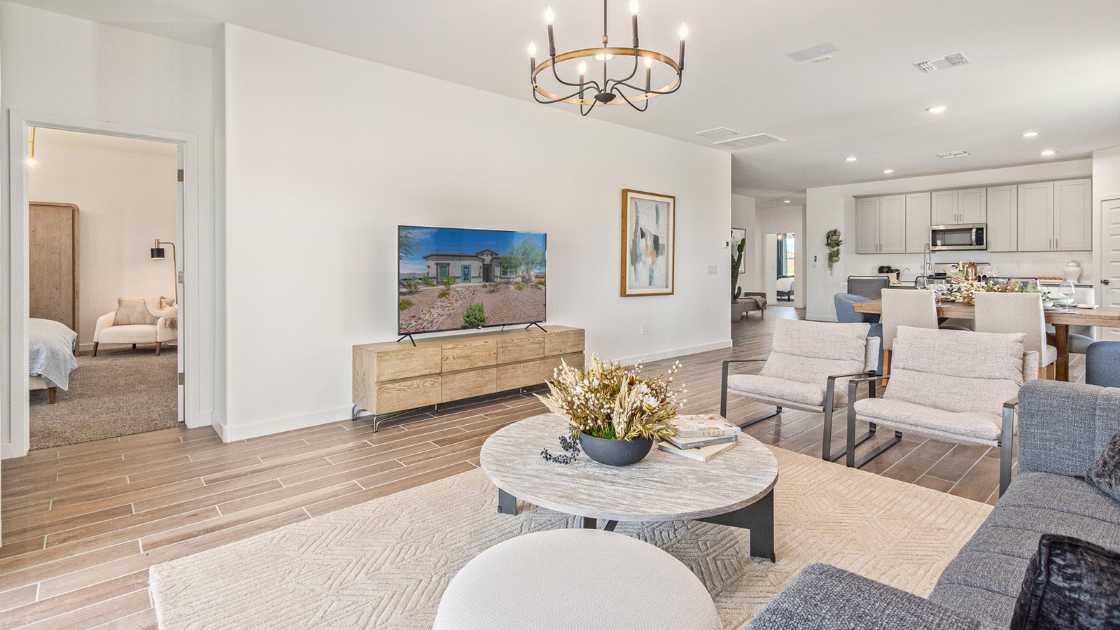 Welcome to The Gaven plan, a spacious single-story new home at The Oasis at Rocking K, where modern living meets the serene beauty of the Arizona landscape. This thoughtfully crafted residence offers 1,815 square feet of well-designed living space, featuring four bedrooms and two full bathrooms, perfect for families who value both comfort and style.  As you step through the front door, you’ll be greeted by a bright and airy entryway that seamlessly transitions into the heart of the home. The open layout connects the great room, dining area, and kitchen, creating an ideal environment for both everyday living and entertaining. The kitchen is a culinary haven, equipped with state-of-the-art appliances, a spacious pantry, and elegant quartz countertops that extend to a large island, perfect for meal prep or casual dining.  The primary suite, nestled at the rear of the home, offers a peaceful retreat with a generously sized walk-in closet and a luxurious en-suite bathroom. The additional three bedrooms are strategically placed to provide privacy and convenience, making them perfect for children, guests, or even a home office. Outside, the covered patio extends your living space, ideal for enjoying Arizona’s stunning sunsets. The front yard is fully landscaped and equipped with an auto drip irrigation system, ensuring your home’s curb appeal is maintained with ease.  Each home at The Oasis at Rocking K, including The Gaven plan, is outfitted with D.R. Horton’s Home is Connected® Smart Home package, featuring a smart thermostat, video doorbell, keyless entry, and Wi-Fi-enabled garage door opener. Energy efficiency is a cornerstone of the design, with features like spray foam insulation, tankless water heaters, and LED lighting, all contributing to long-term savings and environmental sustainability.  The Oasis at Rocking K isn’t just a place to live; it’s a vibrant community with a wealth of amenities, from scenic walking trails to sports courts and playgrounds, ensuring that there’s always something for everyone. Embrace the lifestyle you’ve always dreamed of in The Gaven plan—a perfect blend of comfort, convenience, and Arizona charm.