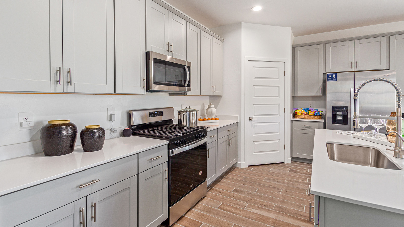 Welcome to The Gaven plan, a spacious single-story new home at The Oasis at Rocking K, where modern living meets the serene beauty of the Arizona landscape. This thoughtfully crafted residence offers 1,815 square feet of well-designed living space, featuring four bedrooms and two full bathrooms, perfect for families who value both comfort and style.  As you step through the front door, you’ll be greeted by a bright and airy entryway that seamlessly transitions into the heart of the home. The open layout connects the great room, dining area, and kitchen, creating an ideal environment for both everyday living and entertaining. The kitchen is a culinary haven, equipped with state-of-the-art appliances, a spacious pantry, and elegant quartz countertops that extend to a large island, perfect for meal prep or casual dining.  The primary suite, nestled at the rear of the home, offers a peaceful retreat with a generously sized walk-in closet and a luxurious en-suite bathroom. The additional three bedrooms are strategically placed to provide privacy and convenience, making them perfect for children, guests, or even a home office. Outside, the covered patio extends your living space, ideal for enjoying Arizona’s stunning sunsets. The front yard is fully landscaped and equipped with an auto drip irrigation system, ensuring your home’s curb appeal is maintained with ease.  Each home at The Oasis at Rocking K, including The Gaven plan, is outfitted with D.R. Horton’s Home is Connected® Smart Home package, featuring a smart thermostat, video doorbell, keyless entry, and Wi-Fi-enabled garage door opener. Energy efficiency is a cornerstone of the design, with features like spray foam insulation, tankless water heaters, and LED lighting, all contributing to long-term savings and environmental sustainability.  The Oasis at Rocking K isn’t just a place to live; it’s a vibrant community with a wealth of amenities, from scenic walking trails to sports courts and playgrounds, ensuring that there’s always something for everyone. Embrace the lifestyle you’ve always dreamed of in The Gaven plan—a perfect blend of comfort, convenience, and Arizona charm.