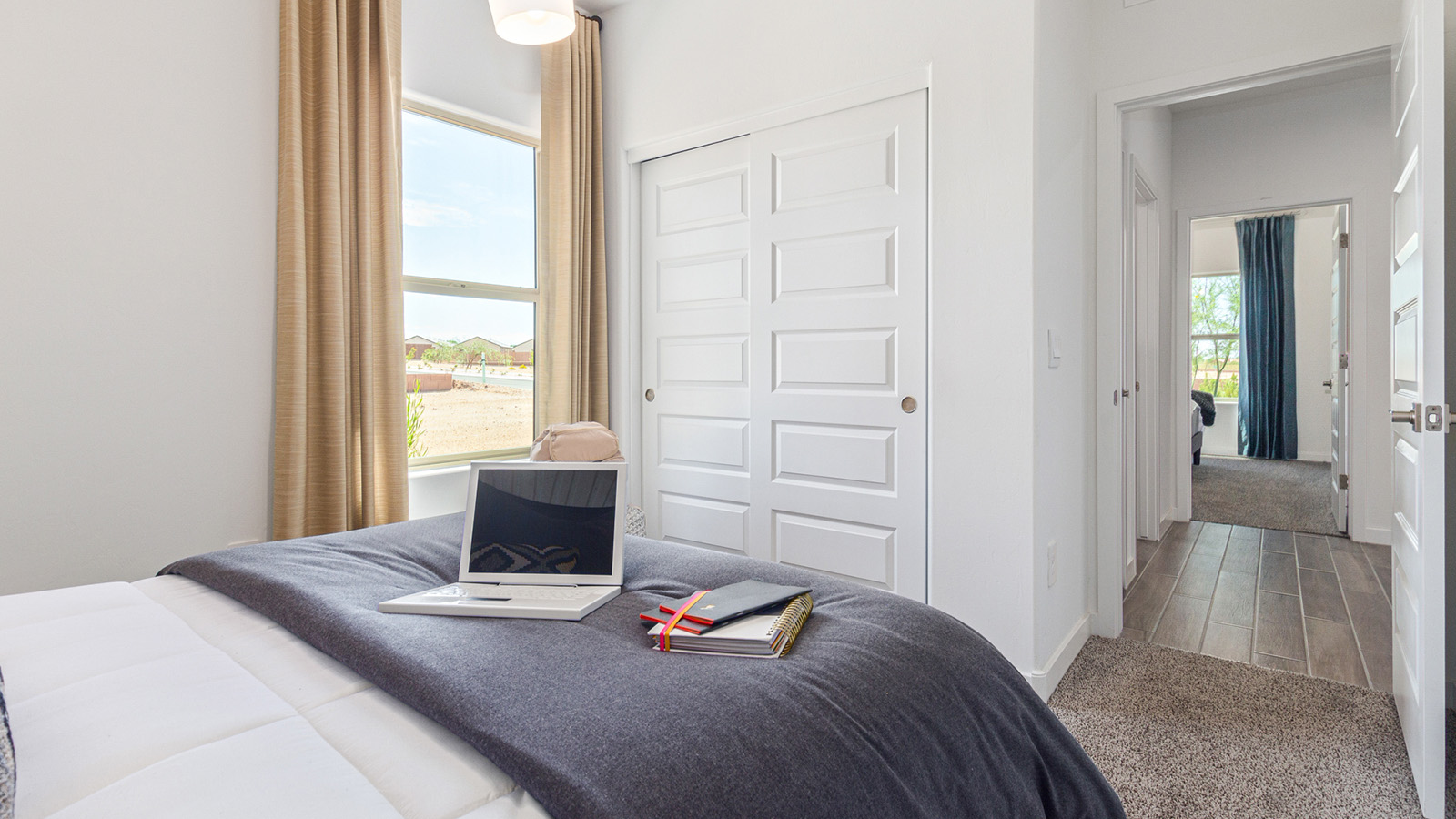 Welcome to The Gaven plan, a spacious single-story new home at The Oasis at Rocking K, where modern living meets the serene beauty of the Arizona landscape. This thoughtfully crafted residence offers 1,815 square feet of well-designed living space, featuring four bedrooms and two full bathrooms, perfect for families who value both comfort and style.  As you step through the front door, you’ll be greeted by a bright and airy entryway that seamlessly transitions into the heart of the home. The open layout connects the great room, dining area, and kitchen, creating an ideal environment for both everyday living and entertaining. The kitchen is a culinary haven, equipped with state-of-the-art appliances, a spacious pantry, and elegant quartz countertops that extend to a large island, perfect for meal prep or casual dining.  The primary suite, nestled at the rear of the home, offers a peaceful retreat with a generously sized walk-in closet and a luxurious en-suite bathroom. The additional three bedrooms are strategically placed to provide privacy and convenience, making them perfect for children, guests, or even a home office. Outside, the covered patio extends your living space, ideal for enjoying Arizona’s stunning sunsets. The front yard is fully landscaped and equipped with an auto drip irrigation system, ensuring your home’s curb appeal is maintained with ease.  Each home at The Oasis at Rocking K, including The Gaven plan, is outfitted with D.R. Horton’s Home is Connected® Smart Home package, featuring a smart thermostat, video doorbell, keyless entry, and Wi-Fi-enabled garage door opener. Energy efficiency is a cornerstone of the design, with features like spray foam insulation, tankless water heaters, and LED lighting, all contributing to long-term savings and environmental sustainability.  The Oasis at Rocking K isn’t just a place to live; it’s a vibrant community with a wealth of amenities, from scenic walking trails to sports courts and playgrounds, ensuring that there’s always something for everyone. Embrace the lifestyle you’ve always dreamed of in The Gaven plan—a perfect blend of comfort, convenience, and Arizona charm.