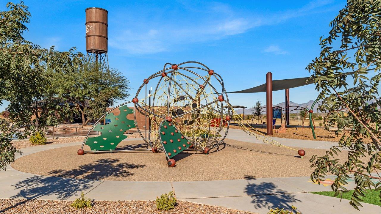 Welcome to The Gaven plan, a spacious single-story new home at The Oasis at Rocking K, where modern living meets the serene beauty of the Arizona landscape. This thoughtfully crafted residence offers 1,815 square feet of well-designed living space, featuring four bedrooms and two full bathrooms, perfect for families who value both comfort and style.  As you step through the front door, you’ll be greeted by a bright and airy entryway that seamlessly transitions into the heart of the home. The open layout connects the great room, dining area, and kitchen, creating an ideal environment for both everyday living and entertaining. The kitchen is a culinary haven, equipped with state-of-the-art appliances, a spacious pantry, and elegant quartz countertops that extend to a large island, perfect for meal prep or casual dining.  The primary suite, nestled at the rear of the home, offers a peaceful retreat with a generously sized walk-in closet and a luxurious en-suite bathroom. The additional three bedrooms are strategically placed to provide privacy and convenience, making them perfect for children, guests, or even a home office. Outside, the covered patio extends your living space, ideal for enjoying Arizona’s stunning sunsets. The front yard is fully landscaped and equipped with an auto drip irrigation system, ensuring your home’s curb appeal is maintained with ease.  Each home at The Oasis at Rocking K, including The Gaven plan, is outfitted with D.R. Horton’s Home is Connected® Smart Home package, featuring a smart thermostat, video doorbell, keyless entry, and Wi-Fi-enabled garage door opener. Energy efficiency is a cornerstone of the design, with features like spray foam insulation, tankless water heaters, and LED lighting, all contributing to long-term savings and environmental sustainability.  The Oasis at Rocking K isn’t just a place to live; it’s a vibrant community with a wealth of amenities, from scenic walking trails to sports courts and playgrounds, ensuring that there’s always something for everyone. Embrace the lifestyle you’ve always dreamed of in The Gaven plan—a perfect blend of comfort, convenience, and Arizona charm.