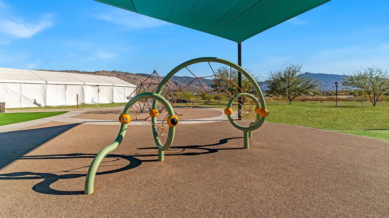 Welcome to The Gaven plan, a spacious single-story new home at The Oasis at Rocking K, where modern living meets the serene beauty of the Arizona landscape. This thoughtfully crafted residence offers 1,815 square feet of well-designed living space, featuring four bedrooms and two full bathrooms, perfect for families who value both comfort and style.  As you step through the front door, you’ll be greeted by a bright and airy entryway that seamlessly transitions into the heart of the home. The open layout connects the great room, dining area, and kitchen, creating an ideal environment for both everyday living and entertaining. The kitchen is a culinary haven, equipped with state-of-the-art appliances, a spacious pantry, and elegant quartz countertops that extend to a large island, perfect for meal prep or casual dining.  The primary suite, nestled at the rear of the home, offers a peaceful retreat with a generously sized walk-in closet and a luxurious en-suite bathroom. The additional three bedrooms are strategically placed to provide privacy and convenience, making them perfect for children, guests, or even a home office. Outside, the covered patio extends your living space, ideal for enjoying Arizona’s stunning sunsets. The front yard is fully landscaped and equipped with an auto drip irrigation system, ensuring your home’s curb appeal is maintained with ease.  Each home at The Oasis at Rocking K, including The Gaven plan, is outfitted with D.R. Horton’s Home is Connected® Smart Home package, featuring a smart thermostat, video doorbell, keyless entry, and Wi-Fi-enabled garage door opener. Energy efficiency is a cornerstone of the design, with features like spray foam insulation, tankless water heaters, and LED lighting, all contributing to long-term savings and environmental sustainability.  The Oasis at Rocking K isn’t just a place to live; it’s a vibrant community with a wealth of amenities, from scenic walking trails to sports courts and playgrounds, ensuring that there’s always something for everyone. Embrace the lifestyle you’ve always dreamed of in The Gaven plan—a perfect blend of comfort, convenience, and Arizona charm.