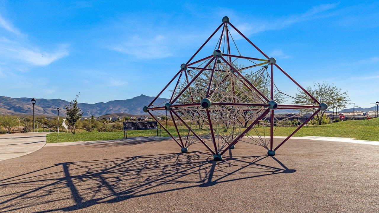 Welcome to The Gaven plan, a spacious single-story new home at The Oasis at Rocking K, where modern living meets the serene beauty of the Arizona landscape. This thoughtfully crafted residence offers 1,815 square feet of well-designed living space, featuring four bedrooms and two full bathrooms, perfect for families who value both comfort and style.  As you step through the front door, you’ll be greeted by a bright and airy entryway that seamlessly transitions into the heart of the home. The open layout connects the great room, dining area, and kitchen, creating an ideal environment for both everyday living and entertaining. The kitchen is a culinary haven, equipped with state-of-the-art appliances, a spacious pantry, and elegant quartz countertops that extend to a large island, perfect for meal prep or casual dining.  The primary suite, nestled at the rear of the home, offers a peaceful retreat with a generously sized walk-in closet and a luxurious en-suite bathroom. The additional three bedrooms are strategically placed to provide privacy and convenience, making them perfect for children, guests, or even a home office. Outside, the covered patio extends your living space, ideal for enjoying Arizona’s stunning sunsets. The front yard is fully landscaped and equipped with an auto drip irrigation system, ensuring your home’s curb appeal is maintained with ease.  Each home at The Oasis at Rocking K, including The Gaven plan, is outfitted with D.R. Horton’s Home is Connected® Smart Home package, featuring a smart thermostat, video doorbell, keyless entry, and Wi-Fi-enabled garage door opener. Energy efficiency is a cornerstone of the design, with features like spray foam insulation, tankless water heaters, and LED lighting, all contributing to long-term savings and environmental sustainability.  The Oasis at Rocking K isn’t just a place to live; it’s a vibrant community with a wealth of amenities, from scenic walking trails to sports courts and playgrounds, ensuring that there’s always something for everyone. Embrace the lifestyle you’ve always dreamed of in The Gaven plan—a perfect blend of comfort, convenience, and Arizona charm.