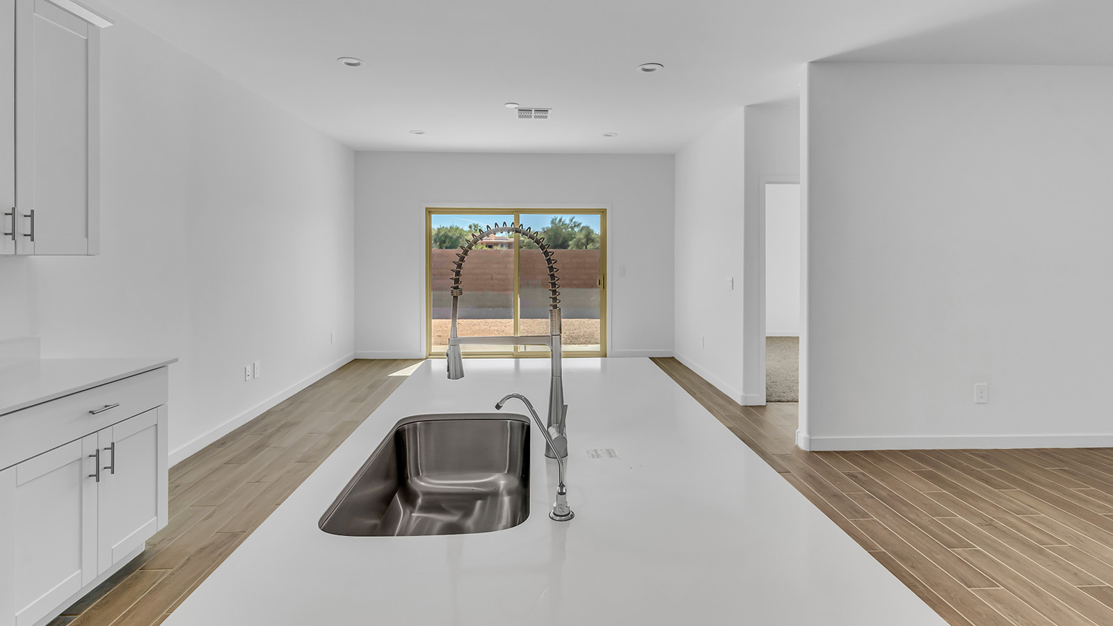 Discover The Harris, a beautifully designed new home at The Oasis at Rocking K, located in the serene surroundings of Vail, Arizona.  This charming one-story new home offers a seamless blend of style, functionality, and comfort, perfect for families and individuals alike. The Harris spans 1,856 square feet and includes four spacious bedrooms, two-and-a-half bathrooms, and a two-car garage, all meticulously crafted to meet the needs of modern living.  The exterior of The Harris offers three elevation options, each featuring D.R. Horton’s signature Spanish lace stucco, tile roofs, and professionally landscaped front yards with auto drip irrigation, adding to the home’s curb appeal. Inside, you’re greeted by an inviting foyer that leads to an open-concept living area, where the great room flows effortlessly into the dining area and a modern kitchen.  The kitchen is a chef's dream, equipped with top-of-the-line stainless steel appliances, quartz countertops, a large center island, and 42” shaker-style cabinets with stylish cabinet pulls. Adjacent to the kitchen, the dining area is perfect for family meals or entertaining guests. The great room, with its ample natural light and direct access to the covered patio, provides a perfect space for relaxation and gatherings.  The primary bedroom is a private sanctuary located at the back of the home, offering tranquility and easy access to the backyard. It features a walk-in closet and a luxurious en-suite bathroom with dual sinks and a large walk-in shower. The additional three bedrooms are generously sized, with two sharing a well-appointed full bathroom. A powder room, strategically placed near the living areas, adds convenience for guests.  Living at The Oasis at Rocking K means enjoying a variety of amenities, including ramadas, picnic areas, and access to the greater Rocking K master-planned community’s parks, walking trails, recreational facilities and events. Each home in this community also comes equipped with D.R. Horton’s Home is Connected® Smart Home package, offering the latest in modern living with features like a smart thermostat, video doorbell, and more.  Whether you’re looking for a home that offers space, style, or a sense of community, The Harris at The Oasis at Rocking K provides it all in a location that’s close to everything you need in Vail, Arizona.