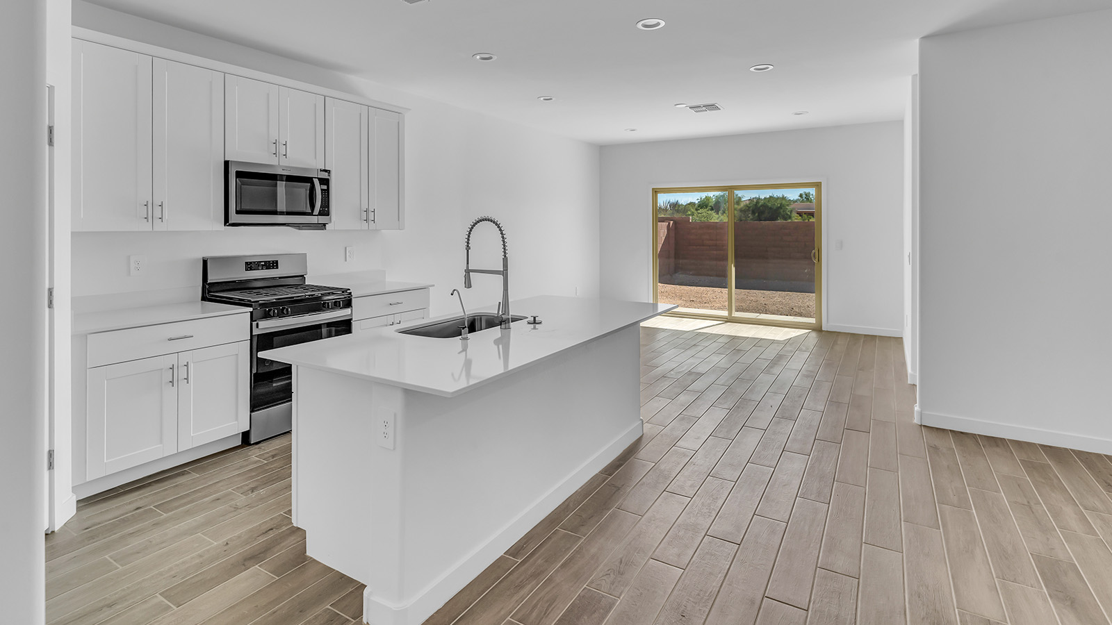 Discover The Harris, a beautifully designed new home at The Oasis at Rocking K, located in the serene surroundings of Vail, Arizona.  This charming one-story new home offers a seamless blend of style, functionality, and comfort, perfect for families and individuals alike. The Harris spans 1,856 square feet and includes four spacious bedrooms, two-and-a-half bathrooms, and a two-car garage, all meticulously crafted to meet the needs of modern living.  The exterior of The Harris offers three elevation options, each featuring D.R. Horton’s signature Spanish lace stucco, tile roofs, and professionally landscaped front yards with auto drip irrigation, adding to the home’s curb appeal. Inside, you’re greeted by an inviting foyer that leads to an open-concept living area, where the great room flows effortlessly into the dining area and a modern kitchen.  The kitchen is a chef's dream, equipped with top-of-the-line stainless steel appliances, quartz countertops, a large center island, and 42” shaker-style cabinets with stylish cabinet pulls. Adjacent to the kitchen, the dining area is perfect for family meals or entertaining guests. The great room, with its ample natural light and direct access to the covered patio, provides a perfect space for relaxation and gatherings.  The primary bedroom is a private sanctuary located at the back of the home, offering tranquility and easy access to the backyard. It features a walk-in closet and a luxurious en-suite bathroom with dual sinks and a large walk-in shower. The additional three bedrooms are generously sized, with two sharing a well-appointed full bathroom. A powder room, strategically placed near the living areas, adds convenience for guests.  Living at The Oasis at Rocking K means enjoying a variety of amenities, including ramadas, picnic areas, and access to the greater Rocking K master-planned community’s parks, walking trails, recreational facilities and events. Each home in this community also comes equipped with D.R. Horton’s Home is Connected® Smart Home package, offering the latest in modern living with features like a smart thermostat, video doorbell, and more.  Whether you’re looking for a home that offers space, style, or a sense of community, The Harris at The Oasis at Rocking K provides it all in a location that’s close to everything you need in Vail, Arizona.