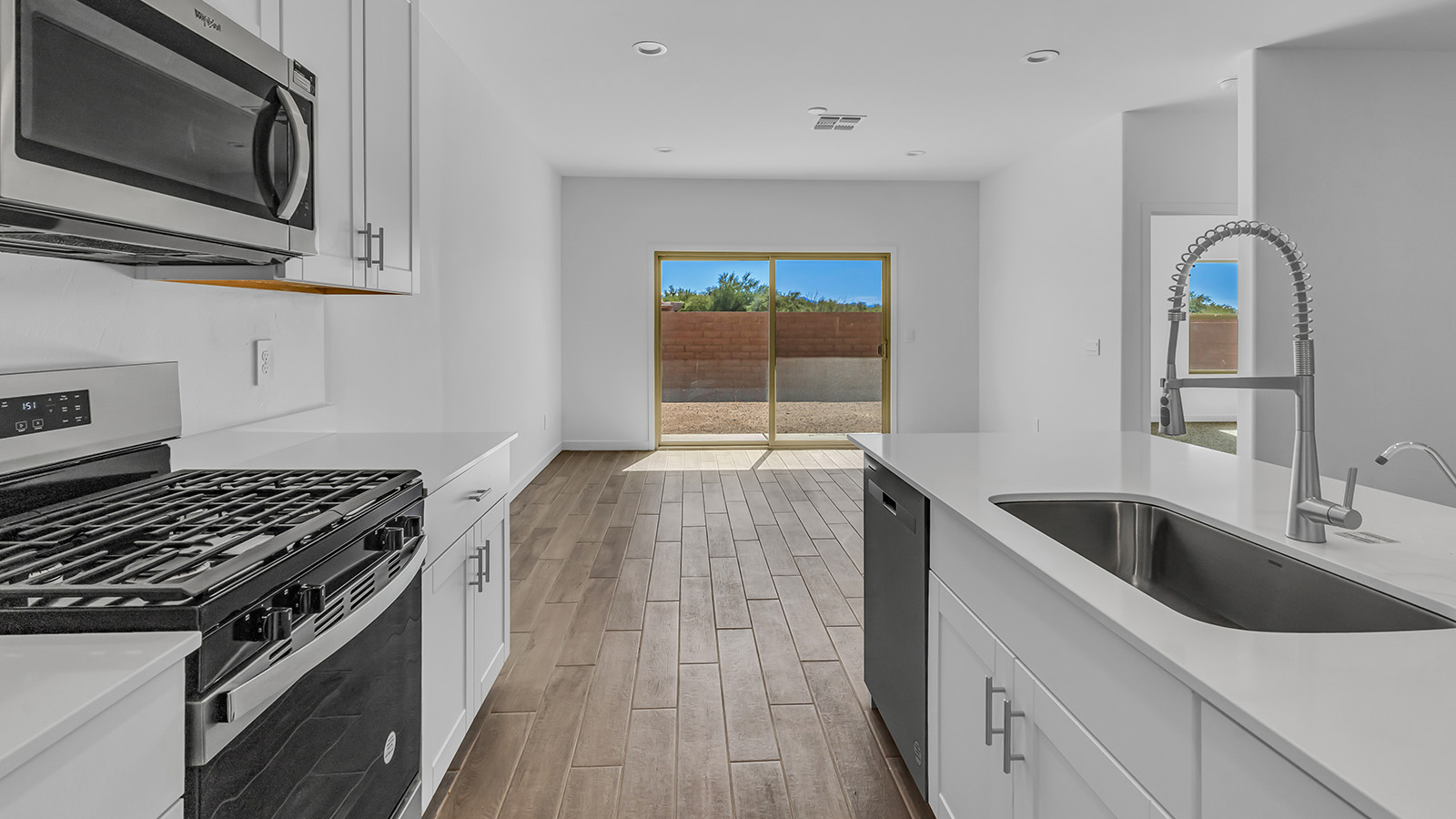 Discover The Harris, a beautifully designed new home at The Oasis at Rocking K, located in the serene surroundings of Vail, Arizona.  This charming one-story new home offers a seamless blend of style, functionality, and comfort, perfect for families and individuals alike. The Harris spans 1,856 square feet and includes four spacious bedrooms, two-and-a-half bathrooms, and a two-car garage, all meticulously crafted to meet the needs of modern living.  The exterior of The Harris offers three elevation options, each featuring D.R. Horton’s signature Spanish lace stucco, tile roofs, and professionally landscaped front yards with auto drip irrigation, adding to the home’s curb appeal. Inside, you’re greeted by an inviting foyer that leads to an open-concept living area, where the great room flows effortlessly into the dining area and a modern kitchen.  The kitchen is a chef's dream, equipped with top-of-the-line stainless steel appliances, quartz countertops, a large center island, and 42” shaker-style cabinets with stylish cabinet pulls. Adjacent to the kitchen, the dining area is perfect for family meals or entertaining guests. The great room, with its ample natural light and direct access to the covered patio, provides a perfect space for relaxation and gatherings.  The primary bedroom is a private sanctuary located at the back of the home, offering tranquility and easy access to the backyard. It features a walk-in closet and a luxurious en-suite bathroom with dual sinks and a large walk-in shower. The additional three bedrooms are generously sized, with two sharing a well-appointed full bathroom. A powder room, strategically placed near the living areas, adds convenience for guests.  Living at The Oasis at Rocking K means enjoying a variety of amenities, including ramadas, picnic areas, and access to the greater Rocking K master-planned community’s parks, walking trails, recreational facilities and events. Each home in this community also comes equipped with D.R. Horton’s Home is Connected® Smart Home package, offering the latest in modern living with features like a smart thermostat, video doorbell, and more.  Whether you’re looking for a home that offers space, style, or a sense of community, The Harris at The Oasis at Rocking K provides it all in a location that’s close to everything you need in Vail, Arizona.