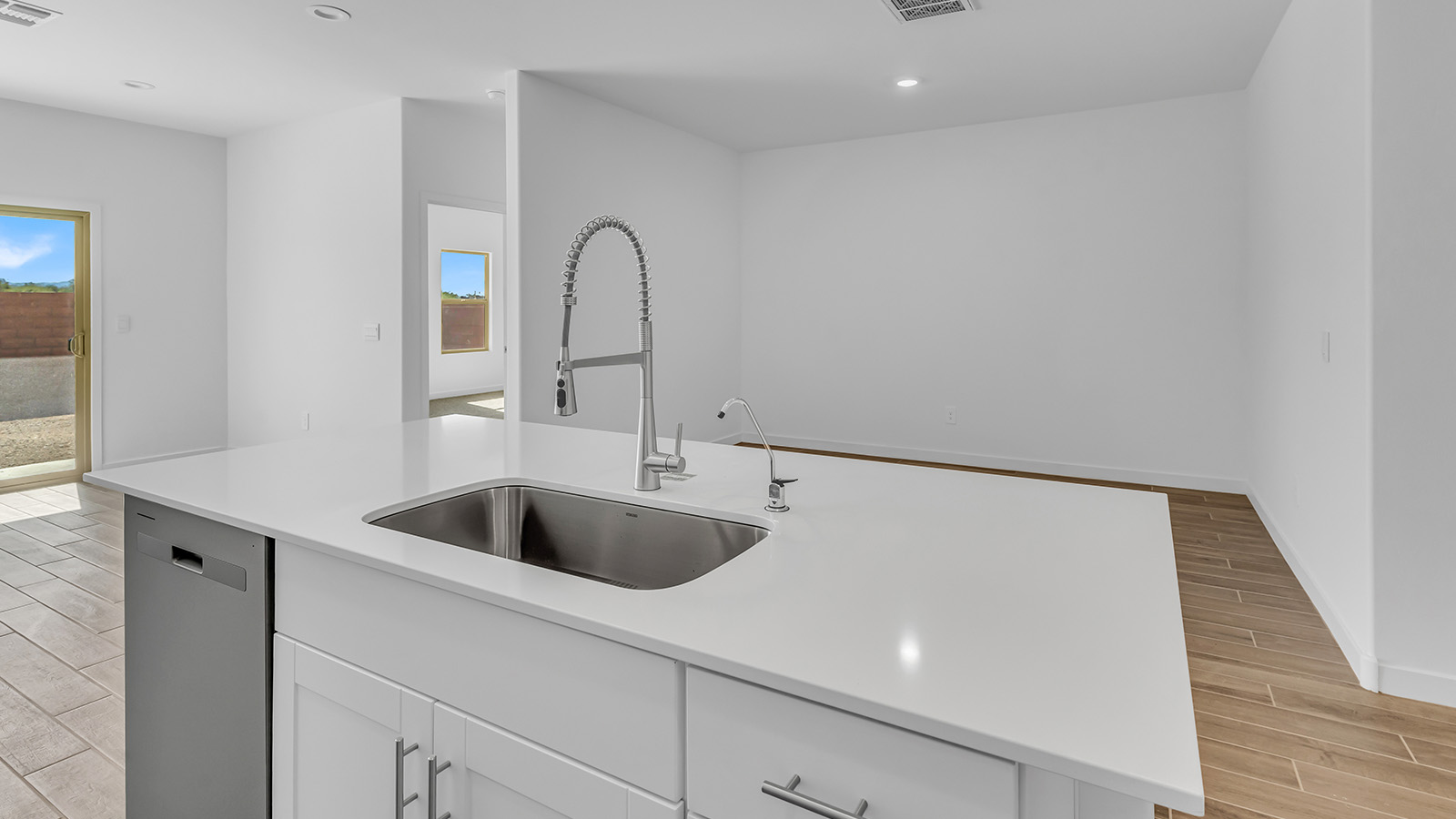 Discover The Harris, a beautifully designed new home at The Oasis at Rocking K, located in the serene surroundings of Vail, Arizona.  This charming one-story new home offers a seamless blend of style, functionality, and comfort, perfect for families and individuals alike. The Harris spans 1,856 square feet and includes four spacious bedrooms, two-and-a-half bathrooms, and a two-car garage, all meticulously crafted to meet the needs of modern living.  The exterior of The Harris offers three elevation options, each featuring D.R. Horton’s signature Spanish lace stucco, tile roofs, and professionally landscaped front yards with auto drip irrigation, adding to the home’s curb appeal. Inside, you’re greeted by an inviting foyer that leads to an open-concept living area, where the great room flows effortlessly into the dining area and a modern kitchen.  The kitchen is a chef's dream, equipped with top-of-the-line stainless steel appliances, quartz countertops, a large center island, and 42” shaker-style cabinets with stylish cabinet pulls. Adjacent to the kitchen, the dining area is perfect for family meals or entertaining guests. The great room, with its ample natural light and direct access to the covered patio, provides a perfect space for relaxation and gatherings.  The primary bedroom is a private sanctuary located at the back of the home, offering tranquility and easy access to the backyard. It features a walk-in closet and a luxurious en-suite bathroom with dual sinks and a large walk-in shower. The additional three bedrooms are generously sized, with two sharing a well-appointed full bathroom. A powder room, strategically placed near the living areas, adds convenience for guests.  Living at The Oasis at Rocking K means enjoying a variety of amenities, including ramadas, picnic areas, and access to the greater Rocking K master-planned community’s parks, walking trails, recreational facilities and events. Each home in this community also comes equipped with D.R. Horton’s Home is Connected® Smart Home package, offering the latest in modern living with features like a smart thermostat, video doorbell, and more.  Whether you’re looking for a home that offers space, style, or a sense of community, The Harris at The Oasis at Rocking K provides it all in a location that’s close to everything you need in Vail, Arizona.