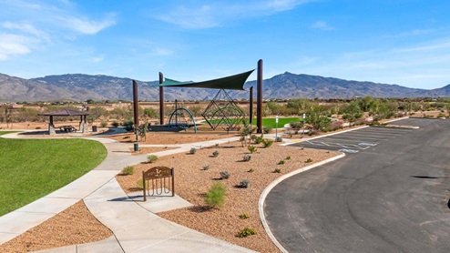 Welcome to The Oasis at Rocking K, a premier D.R. Horton new home community nestled in the picturesque landscapes of Vail, Arizona, where new homes blend seamlessly with the breathtaking surroundings of the Rincon Mountains. Experience the perfect balance of tranquility and modern convenience in this master-planned neighborhood, designed to offer a lifestyle that caters to families, nature enthusiasts, and anyone seeking a peaceful yet connected community. The Oasis at Rocking K features five beautifully designed one-story floor plans ranging from 1,400 to 1,900 square feet, each crafted with the high-quality features and finishes D.R. Horton is known for. Homes in Rocking K feature a Spanish lace stucco exterior, tile roofs, and meticulously landscaped front yards with auto drip irrigation. Inside, you’ll find luxurious quartz countertops in the kitchens and bathrooms, 42” shaker-style cabinets with modern cabinet pulls, and wood-look tile flooring throughout the main living areas. Homes also include covered front porches and back patios, perfect for enjoying Arizona’s stunning sunsets and clear night skies. Each home in The Oasis at Rocking K is equipped with D.R. Horton’s Home is Connected® Smart Home package, which includes a smart thermostat, video doorbell, keyless entry, Wi-Fi-enabled garage door opener, and Deako light switches. Additionally, these homes meet the stringent DOE Zero Energy Ready Home standards, making them not only comfortable and modern but also exceptionally energy-efficient. With features like spray foam insulation, tankless water heaters and LED lighting, these homes are designed to reduce your environmental footprint and provide long-term savings on energy costs. Living at Rocking K means being part of a vibrant, family-oriented community with a strong sense of connection among residents. The Oasis at Rocking K offers a variety of amenities, including ramadas, picnic tables, and grassy areas perfect for gatherings. Residents also have access to the greater Rocking K master-planned neighborhood amenities, such as a splashpad, large event lawn, walking paths, multipurpose fields, basketball and pickleball courts, and an innovative playground with a zip-line and jungle gym. The new K-8 school, set to open in 2025, is just one of the many features that make Rocking K ideal for families. Life at Rocking K is further enriched by a lively calendar of lifestyle events, thoughtfully organized by the Rocking K Homeowners Association. These events are a cornerstone of community life, fostering a strong sense of connection among residents. Whether you’re looking to enjoy a quiet evening star gazing in the park or engage in fun activities with neighbors, there’s always something happening. The quarterly lifestyle calendar is packed with regular and seasonal events, including movie nights in the park, sports and summer camps for kids, and wine tasting events for adults. Families can join hiking groups, participate in trivia nights, or enjoy the various holiday celebrations. The community comes alive during the holidays with loads of themed events, arts and crafts fairs, and car shows. Rocking K’s commitment to providing a dynamic and engaging environment ensures that there’s always an opportunity to make memories and build lasting friendships right in your neighborhood. Residents of Rocking K benefit from easy access to I-10, making commutes to Tucson and surrounding areas a breeze. The community is close to major employers such as Davis-Monthan Air Force Base, Raytheon, and the University of Arizona, as well as top-notch healthcare facilities like TMC Rincon and Northwest Hospital East. The nearby Houghton Town Center and Houghton Rd. business corridor offer convenient shopping, dining, and services. For outdoor enthusiasts, Rocking K is surrounded by natural beauty and recreational opportunities. Explore the hiking and biking trails at Colossal Cave Mountain Park, Saguaro National Park East, and the Arizona Trail. Enjoy golfing at Del Lago Golf Course, or take a short drive to Sonoita for a day trip to Arizona’s Wine Country. Whether it’s hiking, camping, or simply taking in the stunning views, Rocking K is your gateway to the great outdoors. With 360-degree mountain views, calm and quiet evenings, and a location that’s close to everything you need, Rocking K is truly a community where you can thrive. Experience the best of Arizona living at The Oasis at Rocking K, where your new home awaits in a community that offers everything you need for a fulfilling lifestyle.