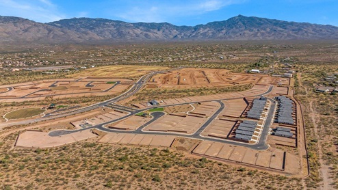 Welcome to The Oasis at Rocking K, a premier D.R. Horton new home community nestled in the picturesque landscapes of Vail, Arizona, where new homes blend seamlessly with the breathtaking surroundings of the Rincon Mountains. Experience the perfect balance of tranquility and modern convenience in this master-planned neighborhood, designed to offer a lifestyle that caters to families, nature enthusiasts, and anyone seeking a peaceful yet connected community. The Oasis at Rocking K features five beautifully designed one-story floor plans ranging from 1,400 to 1,900 square feet, each crafted with the high-quality features and finishes D.R. Horton is known for. Homes in Rocking K feature a Spanish lace stucco exterior, tile roofs, and meticulously landscaped front yards with auto drip irrigation. Inside, you’ll find luxurious quartz countertops in the kitchens and bathrooms, 42” shaker-style cabinets with modern cabinet pulls, and wood-look tile flooring throughout the main living areas. Homes also include covered front porches and back patios, perfect for enjoying Arizona’s stunning sunsets and clear night skies. Each home in The Oasis at Rocking K is equipped with D.R. Horton’s Home is Connected® Smart Home package, which includes a smart thermostat, video doorbell, keyless entry, Wi-Fi-enabled garage door opener, and Deako light switches. Additionally, these homes meet the stringent DOE Zero Energy Ready Home standards, making them not only comfortable and modern but also exceptionally energy-efficient. With features like spray foam insulation, tankless water heaters and LED lighting, these homes are designed to reduce your environmental footprint and provide long-term savings on energy costs. Living at Rocking K means being part of a vibrant, family-oriented community with a strong sense of connection among residents. The Oasis at Rocking K offers a variety of amenities, including ramadas, picnic tables, and grassy areas perfect for gatherings. Residents also have access to the greater Rocking K master-planned neighborhood amenities, such as a splashpad, large event lawn, walking paths, multipurpose fields, basketball and pickleball courts, and an innovative playground with a zip-line and jungle gym. The new K-8 school, set to open in 2025, is just one of the many features that make Rocking K ideal for families. Life at Rocking K is further enriched by a lively calendar of lifestyle events, thoughtfully organized by the Rocking K Homeowners Association. These events are a cornerstone of community life, fostering a strong sense of connection among residents. Whether you’re looking to enjoy a quiet evening star gazing in the park or engage in fun activities with neighbors, there’s always something happening. The quarterly lifestyle calendar is packed with regular and seasonal events, including movie nights in the park, sports and summer camps for kids, and wine tasting events for adults. Families can join hiking groups, participate in trivia nights, or enjoy the various holiday celebrations. The community comes alive during the holidays with loads of themed events, arts and crafts fairs, and car shows. Rocking K’s commitment to providing a dynamic and engaging environment ensures that there’s always an opportunity to make memories and build lasting friendships right in your neighborhood. Residents of Rocking K benefit from easy access to I-10, making commutes to Tucson and surrounding areas a breeze. The community is close to major employers such as Davis-Monthan Air Force Base, Raytheon, and the University of Arizona, as well as top-notch healthcare facilities like TMC Rincon and Northwest Hospital East. The nearby Houghton Town Center and Houghton Rd. business corridor offer convenient shopping, dining, and services. For outdoor enthusiasts, Rocking K is surrounded by natural beauty and recreational opportunities. Explore the hiking and biking trails at Colossal Cave Mountain Park, Saguaro National Park East, and the Arizona Trail. Enjoy golfing at Del Lago Golf Course, or take a short drive to Sonoita for a day trip to Arizona’s Wine Country. Whether it’s hiking, camping, or simply taking in the stunning views, Rocking K is your gateway to the great outdoors. With 360-degree mountain views, calm and quiet evenings, and a location that’s close to everything you need, Rocking K is truly a community where you can thrive. Experience the best of Arizona living at The Oasis at Rocking K, where your new home awaits in a community that offers everything you need for a fulfilling lifestyle.