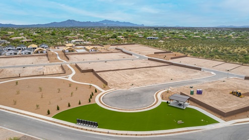 Welcome to The Oasis at Rocking K, a premier D.R. Horton new home community nestled in the picturesque landscapes of Vail, Arizona, where new homes blend seamlessly with the breathtaking surroundings of the Rincon Mountains. Experience the perfect balance of tranquility and modern convenience in this master-planned neighborhood, designed to offer a lifestyle that caters to families, nature enthusiasts, and anyone seeking a peaceful yet connected community. The Oasis at Rocking K features five beautifully designed one-story floor plans ranging from 1,400 to 1,900 square feet, each crafted with the high-quality features and finishes D.R. Horton is known for. Homes in Rocking K feature a Spanish lace stucco exterior, tile roofs, and meticulously landscaped front yards with auto drip irrigation. Inside, you’ll find luxurious quartz countertops in the kitchens and bathrooms, 42” shaker-style cabinets with modern cabinet pulls, and wood-look tile flooring throughout the main living areas. Homes also include covered front porches and back patios, perfect for enjoying Arizona’s stunning sunsets and clear night skies. Each home in The Oasis at Rocking K is equipped with D.R. Horton’s Home is Connected® Smart Home package, which includes a smart thermostat, video doorbell, keyless entry, Wi-Fi-enabled garage door opener, and Deako light switches. Additionally, these homes meet the stringent DOE Zero Energy Ready Home standards, making them not only comfortable and modern but also exceptionally energy-efficient. With features like spray foam insulation, tankless water heaters and LED lighting, these homes are designed to reduce your environmental footprint and provide long-term savings on energy costs. Living at Rocking K means being part of a vibrant, family-oriented community with a strong sense of connection among residents. The Oasis at Rocking K offers a variety of amenities, including ramadas, picnic tables, and grassy areas perfect for gatherings. Residents also have access to the greater Rocking K master-planned neighborhood amenities, such as a splashpad, large event lawn, walking paths, multipurpose fields, basketball and pickleball courts, and an innovative playground with a zip-line and jungle gym. The new K-8 school, set to open in 2025, is just one of the many features that make Rocking K ideal for families. Life at Rocking K is further enriched by a lively calendar of lifestyle events, thoughtfully organized by the Rocking K Homeowners Association. These events are a cornerstone of community life, fostering a strong sense of connection among residents. Whether you’re looking to enjoy a quiet evening star gazing in the park or engage in fun activities with neighbors, there’s always something happening. The quarterly lifestyle calendar is packed with regular and seasonal events, including movie nights in the park, sports and summer camps for kids, and wine tasting events for adults. Families can join hiking groups, participate in trivia nights, or enjoy the various holiday celebrations. The community comes alive during the holidays with loads of themed events, arts and crafts fairs, and car shows. Rocking K’s commitment to providing a dynamic and engaging environment ensures that there’s always an opportunity to make memories and build lasting friendships right in your neighborhood. Residents of Rocking K benefit from easy access to I-10, making commutes to Tucson and surrounding areas a breeze. The community is close to major employers such as Davis-Monthan Air Force Base, Raytheon, and the University of Arizona, as well as top-notch healthcare facilities like TMC Rincon and Northwest Hospital East. The nearby Houghton Town Center and Houghton Rd. business corridor offer convenient shopping, dining, and services. For outdoor enthusiasts, Rocking K is surrounded by natural beauty and recreational opportunities. Explore the hiking and biking trails at Colossal Cave Mountain Park, Saguaro National Park East, and the Arizona Trail. Enjoy golfing at Del Lago Golf Course, or take a short drive to Sonoita for a day trip to Arizona’s Wine Country. Whether it’s hiking, camping, or simply taking in the stunning views, Rocking K is your gateway to the great outdoors. With 360-degree mountain views, calm and quiet evenings, and a location that’s close to everything you need, Rocking K is truly a community where you can thrive. Experience the best of Arizona living at The Oasis at Rocking K, where your new home awaits in a community that offers everything you need for a fulfilling lifestyle.