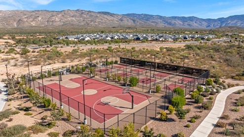 Welcome to The Oasis at Rocking K, a premier D.R. Horton new home community nestled in the picturesque landscapes of Vail, Arizona, where new homes blend seamlessly with the breathtaking surroundings of the Rincon Mountains. Experience the perfect balance of tranquility and modern convenience in this master-planned neighborhood, designed to offer a lifestyle that caters to families, nature enthusiasts, and anyone seeking a peaceful yet connected community. The Oasis at Rocking K features five beautifully designed one-story floor plans ranging from 1,400 to 1,900 square feet, each crafted with the high-quality features and finishes D.R. Horton is known for. Homes in Rocking K feature a Spanish lace stucco exterior, tile roofs, and meticulously landscaped front yards with auto drip irrigation. Inside, you’ll find luxurious quartz countertops in the kitchens and bathrooms, 42” shaker-style cabinets with modern cabinet pulls, and wood-look tile flooring throughout the main living areas. Homes also include covered front porches and back patios, perfect for enjoying Arizona’s stunning sunsets and clear night skies. Each home in The Oasis at Rocking K is equipped with D.R. Horton’s Home is Connected® Smart Home package, which includes a smart thermostat, video doorbell, keyless entry, Wi-Fi-enabled garage door opener, and Deako light switches. Additionally, these homes meet the stringent DOE Zero Energy Ready Home standards, making them not only comfortable and modern but also exceptionally energy-efficient. With features like spray foam insulation, tankless water heaters and LED lighting, these homes are designed to reduce your environmental footprint and provide long-term savings on energy costs. Living at Rocking K means being part of a vibrant, family-oriented community with a strong sense of connection among residents. The Oasis at Rocking K offers a variety of amenities, including ramadas, picnic tables, and grassy areas perfect for gatherings. Residents also have access to the greater Rocking K master-planned neighborhood amenities, such as a splashpad, large event lawn, walking paths, multipurpose fields, basketball and pickleball courts, and an innovative playground with a zip-line and jungle gym. The new K-8 school, set to open in 2025, is just one of the many features that make Rocking K ideal for families. Life at Rocking K is further enriched by a lively calendar of lifestyle events, thoughtfully organized by the Rocking K Homeowners Association. These events are a cornerstone of community life, fostering a strong sense of connection among residents. Whether you’re looking to enjoy a quiet evening star gazing in the park or engage in fun activities with neighbors, there’s always something happening. The quarterly lifestyle calendar is packed with regular and seasonal events, including movie nights in the park, sports and summer camps for kids, and wine tasting events for adults. Families can join hiking groups, participate in trivia nights, or enjoy the various holiday celebrations. The community comes alive during the holidays with loads of themed events, arts and crafts fairs, and car shows. Rocking K’s commitment to providing a dynamic and engaging environment ensures that there’s always an opportunity to make memories and build lasting friendships right in your neighborhood. Residents of Rocking K benefit from easy access to I-10, making commutes to Tucson and surrounding areas a breeze. The community is close to major employers such as Davis-Monthan Air Force Base, Raytheon, and the University of Arizona, as well as top-notch healthcare facilities like TMC Rincon and Northwest Hospital East. The nearby Houghton Town Center and Houghton Rd. business corridor offer convenient shopping, dining, and services. For outdoor enthusiasts, Rocking K is surrounded by natural beauty and recreational opportunities. Explore the hiking and biking trails at Colossal Cave Mountain Park, Saguaro National Park East, and the Arizona Trail. Enjoy golfing at Del Lago Golf Course, or take a short drive to Sonoita for a day trip to Arizona’s Wine Country. Whether it’s hiking, camping, or simply taking in the stunning views, Rocking K is your gateway to the great outdoors. With 360-degree mountain views, calm and quiet evenings, and a location that’s close to everything you need, Rocking K is truly a community where you can thrive. Experience the best of Arizona living at The Oasis at Rocking K, where your new home awaits in a community that offers everything you need for a fulfilling lifestyle.