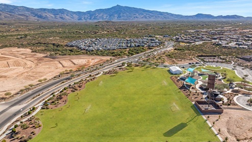 Welcome to The Oasis at Rocking K, a premier D.R. Horton new home community nestled in the picturesque landscapes of Vail, Arizona, where new homes blend seamlessly with the breathtaking surroundings of the Rincon Mountains. Experience the perfect balance of tranquility and modern convenience in this master-planned neighborhood, designed to offer a lifestyle that caters to families, nature enthusiasts, and anyone seeking a peaceful yet connected community. The Oasis at Rocking K features five beautifully designed one-story floor plans ranging from 1,400 to 1,900 square feet, each crafted with the high-quality features and finishes D.R. Horton is known for. Homes in Rocking K feature a Spanish lace stucco exterior, tile roofs, and meticulously landscaped front yards with auto drip irrigation. Inside, you’ll find luxurious quartz countertops in the kitchens and bathrooms, 42” shaker-style cabinets with modern cabinet pulls, and wood-look tile flooring throughout the main living areas. Homes also include covered front porches and back patios, perfect for enjoying Arizona’s stunning sunsets and clear night skies. Each home in The Oasis at Rocking K is equipped with D.R. Horton’s Home is Connected® Smart Home package, which includes a smart thermostat, video doorbell, keyless entry, Wi-Fi-enabled garage door opener, and Deako light switches. Additionally, these homes meet the stringent DOE Zero Energy Ready Home standards, making them not only comfortable and modern but also exceptionally energy-efficient. With features like spray foam insulation, tankless water heaters and LED lighting, these homes are designed to reduce your environmental footprint and provide long-term savings on energy costs. Living at Rocking K means being part of a vibrant, family-oriented community with a strong sense of connection among residents. The Oasis at Rocking K offers a variety of amenities, including ramadas, picnic tables, and grassy areas perfect for gatherings. Residents also have access to the greater Rocking K master-planned neighborhood amenities, such as a splashpad, large event lawn, walking paths, multipurpose fields, basketball and pickleball courts, and an innovative playground with a zip-line and jungle gym. The new K-8 school, set to open in 2025, is just one of the many features that make Rocking K ideal for families. Life at Rocking K is further enriched by a lively calendar of lifestyle events, thoughtfully organized by the Rocking K Homeowners Association. These events are a cornerstone of community life, fostering a strong sense of connection among residents. Whether you’re looking to enjoy a quiet evening star gazing in the park or engage in fun activities with neighbors, there’s always something happening. The quarterly lifestyle calendar is packed with regular and seasonal events, including movie nights in the park, sports and summer camps for kids, and wine tasting events for adults. Families can join hiking groups, participate in trivia nights, or enjoy the various holiday celebrations. The community comes alive during the holidays with loads of themed events, arts and crafts fairs, and car shows. Rocking K’s commitment to providing a dynamic and engaging environment ensures that there’s always an opportunity to make memories and build lasting friendships right in your neighborhood. Residents of Rocking K benefit from easy access to I-10, making commutes to Tucson and surrounding areas a breeze. The community is close to major employers such as Davis-Monthan Air Force Base, Raytheon, and the University of Arizona, as well as top-notch healthcare facilities like TMC Rincon and Northwest Hospital East. The nearby Houghton Town Center and Houghton Rd. business corridor offer convenient shopping, dining, and services. For outdoor enthusiasts, Rocking K is surrounded by natural beauty and recreational opportunities. Explore the hiking and biking trails at Colossal Cave Mountain Park, Saguaro National Park East, and the Arizona Trail. Enjoy golfing at Del Lago Golf Course, or take a short drive to Sonoita for a day trip to Arizona’s Wine Country. Whether it’s hiking, camping, or simply taking in the stunning views, Rocking K is your gateway to the great outdoors. With 360-degree mountain views, calm and quiet evenings, and a location that’s close to everything you need, Rocking K is truly a community where you can thrive. Experience the best of Arizona living at The Oasis at Rocking K, where your new home awaits in a community that offers everything you need for a fulfilling lifestyle.