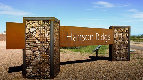 Discover the new homes at Hanson Ridge, a peaceful D.R. Horton community located in the scenic town of Vail, Arizona. Tucked away from the hustle and bustle of city life, Hanson Ridge offers a serene lifestyle with incredible desert landscapes and mountain views, while still providing easy access to I-10, making commutes to Tucson and surrounding areas convenient. Whether you’re seeking tranquility or proximity to modern conveniences, Hanson Ridge delivers the best of both worlds. This thoughtfully planned community features a variety of spacious one- and two-story homes, ranging from 1,300 to 2,500 square feet, designed to accommodate diverse lifestyles. Each home at Hanson Ridge is equipped with high-quality features, including granite countertops in the kitchens and bathrooms, 42" shaker-style cabinets, and beautiful 18"x18" tile flooring. The homes also feature covered front porches and back patios, providing the perfect spaces to enjoy Arizona’s beautiful weather. The community is designed with spacious lots, and generous pool-ready backyards, giving you the flexibility to customize your own outdoor oasis. Hanson Ridge is built with energy efficiency in mind, meeting the DOE Zero Energy Ready Home standards. These high-performance homes are so energy-efficient that a renewable energy system could offset most or all of the home's annual energy use. With advanced features such as a tankless water heater, energy-efficient LED lighting, a smart thermostat and more, these homes offer both comfort and sustainability. Additionally, the Home is Connected® Smart Home package built into every home includes a video doorbell, keyless entry, Deako smart switches a Wi-Fi-enabled garage door opener and more, ensuring that modern convenience is at your fingertips whether you're at home or away. Residents of Hanson Ridge enjoy a strong sense of community, with parks, walking paths, and playgrounds sprinkled throughout the neighborhood, fostering connections among families and neighbors. The Vail Unified School District, renowned for its exceptional educational standards, serves this community, with Acacia Elementary School, Old Vail Middle School, and Cienega High School all located nearby. The location of Hanson Ridge provides residents with easy access to a variety of outdoor and recreational activities. Explore the nearby Rincon Mountains, hike through Saguaro National Park, or visit Colossal Cave Mountain Park and Cienega Creek Natural Preserve. For those who enjoy golfing, Del Lago Golf Course is just minutes away. The community’s proximity to major employers such as Raytheon, UA Tech Park, Davis-Monthan Air Force Base, and the Target Distribution Center makes it an ideal choice for working professionals. In addition to its natural beauty and recreational offerings, Hanson Ridge is just a short drive from the town center, where you’ll find shopping, dining, and entertainment options. Visit the Pima County Fairgrounds, enjoy a movie at Galaxy Theatres, or explore the historic Cienega Bridge landmark. For a weekend getaway, Sonoita’s Wine Country is just 30 minutes away, offering cooler climates, picturesque vineyards, and outdoor adventures. Hanson Ridge offers a unique blend of peaceful, rural living with the convenience of nearby urban amenities. Experience the charm and comfort of Hanson Ridge, where your new home awaits.