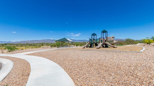 Discover the new homes at Hanson Ridge, a peaceful D.R. Horton community located in the scenic town of Vail, Arizona. Tucked away from the hustle and bustle of city life, Hanson Ridge offers a serene lifestyle with incredible desert landscapes and mountain views, while still providing easy access to I-10, making commutes to Tucson and surrounding areas convenient. Whether you’re seeking tranquility or proximity to modern conveniences, Hanson Ridge delivers the best of both worlds. This thoughtfully planned community features a variety of spacious one- and two-story homes, ranging from 1,300 to 2,500 square feet, designed to accommodate diverse lifestyles. Each home at Hanson Ridge is equipped with high-quality features, including granite countertops in the kitchens and bathrooms, 42" shaker-style cabinets, and beautiful 18"x18" tile flooring. The homes also feature covered front porches and back patios, providing the perfect spaces to enjoy Arizona’s beautiful weather. The community is designed with spacious lots, and generous pool-ready backyards, giving you the flexibility to customize your own outdoor oasis. Hanson Ridge is built with energy efficiency in mind, meeting the DOE Zero Energy Ready Home standards. These high-performance homes are so energy-efficient that a renewable energy system could offset most or all of the home's annual energy use. With advanced features such as a tankless water heater, energy-efficient LED lighting, a smart thermostat and more, these homes offer both comfort and sustainability. Additionally, the Home is Connected® Smart Home package built into every home includes a video doorbell, keyless entry, Deako smart switches a Wi-Fi-enabled garage door opener and more, ensuring that modern convenience is at your fingertips whether you're at home or away. Residents of Hanson Ridge enjoy a strong sense of community, with parks, walking paths, and playgrounds sprinkled throughout the neighborhood, fostering connections among families and neighbors. The Vail Unified School District, renowned for its exceptional educational standards, serves this community, with Acacia Elementary School, Old Vail Middle School, and Cienega High School all located nearby. The location of Hanson Ridge provides residents with easy access to a variety of outdoor and recreational activities. Explore the nearby Rincon Mountains, hike through Saguaro National Park, or visit Colossal Cave Mountain Park and Cienega Creek Natural Preserve. For those who enjoy golfing, Del Lago Golf Course is just minutes away. The community’s proximity to major employers such as Raytheon, UA Tech Park, Davis-Monthan Air Force Base, and the Target Distribution Center makes it an ideal choice for working professionals. In addition to its natural beauty and recreational offerings, Hanson Ridge is just a short drive from the town center, where you’ll find shopping, dining, and entertainment options. Visit the Pima County Fairgrounds, enjoy a movie at Galaxy Theatres, or explore the historic Cienega Bridge landmark. For a weekend getaway, Sonoita’s Wine Country is just 30 minutes away, offering cooler climates, picturesque vineyards, and outdoor adventures. Hanson Ridge offers a unique blend of peaceful, rural living with the convenience of nearby urban amenities. Experience the charm and comfort of Hanson Ridge, where your new home awaits.