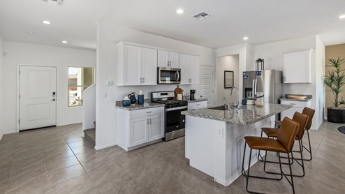 Discover the new homes at Hanson Ridge, a peaceful D.R. Horton community located in the scenic town of Vail, Arizona. Tucked away from the hustle and bustle of city life, Hanson Ridge offers a serene lifestyle with incredible desert landscapes and mountain views, while still providing easy access to I-10, making commutes to Tucson and surrounding areas convenient. Whether you’re seeking tranquility or proximity to modern conveniences, Hanson Ridge delivers the best of both worlds. This thoughtfully planned community features a variety of spacious one- and two-story homes, ranging from 1,300 to 2,500 square feet, designed to accommodate diverse lifestyles. Each home at Hanson Ridge is equipped with high-quality features, including granite countertops in the kitchens and bathrooms, 42" shaker-style cabinets, and beautiful 18"x18" tile flooring. The homes also feature covered front porches and back patios, providing the perfect spaces to enjoy Arizona’s beautiful weather. The community is designed with spacious lots, and generous pool-ready backyards, giving you the flexibility to customize your own outdoor oasis. Hanson Ridge is built with energy efficiency in mind, meeting the DOE Zero Energy Ready Home standards. These high-performance homes are so energy-efficient that a renewable energy system could offset most or all of the home's annual energy use. With advanced features such as a tankless water heater, energy-efficient LED lighting, a smart thermostat and more, these homes offer both comfort and sustainability. Additionally, the Home is Connected® Smart Home package built into every home includes a video doorbell, keyless entry, Deako smart switches a Wi-Fi-enabled garage door opener and more, ensuring that modern convenience is at your fingertips whether you're at home or away. Residents of Hanson Ridge enjoy a strong sense of community, with parks, walking paths, and playgrounds sprinkled throughout the neighborhood, fostering connections among families and neighbors. The Vail Unified School District, renowned for its exceptional educational standards, serves this community, with Acacia Elementary School, Old Vail Middle School, and Cienega High School all located nearby. The location of Hanson Ridge provides residents with easy access to a variety of outdoor and recreational activities. Explore the nearby Rincon Mountains, hike through Saguaro National Park, or visit Colossal Cave Mountain Park and Cienega Creek Natural Preserve. For those who enjoy golfing, Del Lago Golf Course is just minutes away. The community’s proximity to major employers such as Raytheon, UA Tech Park, Davis-Monthan Air Force Base, and the Target Distribution Center makes it an ideal choice for working professionals. In addition to its natural beauty and recreational offerings, Hanson Ridge is just a short drive from the town center, where you’ll find shopping, dining, and entertainment options. Visit the Pima County Fairgrounds, enjoy a movie at Galaxy Theatres, or explore the historic Cienega Bridge landmark. For a weekend getaway, Sonoita’s Wine Country is just 30 minutes away, offering cooler climates, picturesque vineyards, and outdoor adventures. Hanson Ridge offers a unique blend of peaceful, rural living with the convenience of nearby urban amenities. Experience the charm and comfort of Hanson Ridge, where your new home awaits.