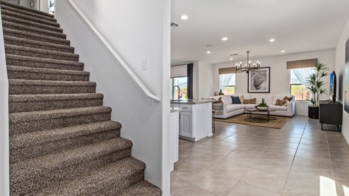 Discover the new homes at Hanson Ridge, a peaceful D.R. Horton community located in the scenic town of Vail, Arizona. Tucked away from the hustle and bustle of city life, Hanson Ridge offers a serene lifestyle with incredible desert landscapes and mountain views, while still providing easy access to I-10, making commutes to Tucson and surrounding areas convenient. Whether you’re seeking tranquility or proximity to modern conveniences, Hanson Ridge delivers the best of both worlds. This thoughtfully planned community features a variety of spacious one- and two-story homes, ranging from 1,300 to 2,500 square feet, designed to accommodate diverse lifestyles. Each home at Hanson Ridge is equipped with high-quality features, including granite countertops in the kitchens and bathrooms, 42" shaker-style cabinets, and beautiful 18"x18" tile flooring. The homes also feature covered front porches and back patios, providing the perfect spaces to enjoy Arizona’s beautiful weather. The community is designed with spacious lots, and generous pool-ready backyards, giving you the flexibility to customize your own outdoor oasis. Hanson Ridge is built with energy efficiency in mind, meeting the DOE Zero Energy Ready Home standards. These high-performance homes are so energy-efficient that a renewable energy system could offset most or all of the home's annual energy use. With advanced features such as a tankless water heater, energy-efficient LED lighting, a smart thermostat and more, these homes offer both comfort and sustainability. Additionally, the Home is Connected® Smart Home package built into every home includes a video doorbell, keyless entry, Deako smart switches a Wi-Fi-enabled garage door opener and more, ensuring that modern convenience is at your fingertips whether you're at home or away. Residents of Hanson Ridge enjoy a strong sense of community, with parks, walking paths, and playgrounds sprinkled throughout the neighborhood, fostering connections among families and neighbors. The Vail Unified School District, renowned for its exceptional educational standards, serves this community, with Acacia Elementary School, Old Vail Middle School, and Cienega High School all located nearby. The location of Hanson Ridge provides residents with easy access to a variety of outdoor and recreational activities. Explore the nearby Rincon Mountains, hike through Saguaro National Park, or visit Colossal Cave Mountain Park and Cienega Creek Natural Preserve. For those who enjoy golfing, Del Lago Golf Course is just minutes away. The community’s proximity to major employers such as Raytheon, UA Tech Park, Davis-Monthan Air Force Base, and the Target Distribution Center makes it an ideal choice for working professionals. In addition to its natural beauty and recreational offerings, Hanson Ridge is just a short drive from the town center, where you’ll find shopping, dining, and entertainment options. Visit the Pima County Fairgrounds, enjoy a movie at Galaxy Theatres, or explore the historic Cienega Bridge landmark. For a weekend getaway, Sonoita’s Wine Country is just 30 minutes away, offering cooler climates, picturesque vineyards, and outdoor adventures. Hanson Ridge offers a unique blend of peaceful, rural living with the convenience of nearby urban amenities. Experience the charm and comfort of Hanson Ridge, where your new home awaits.