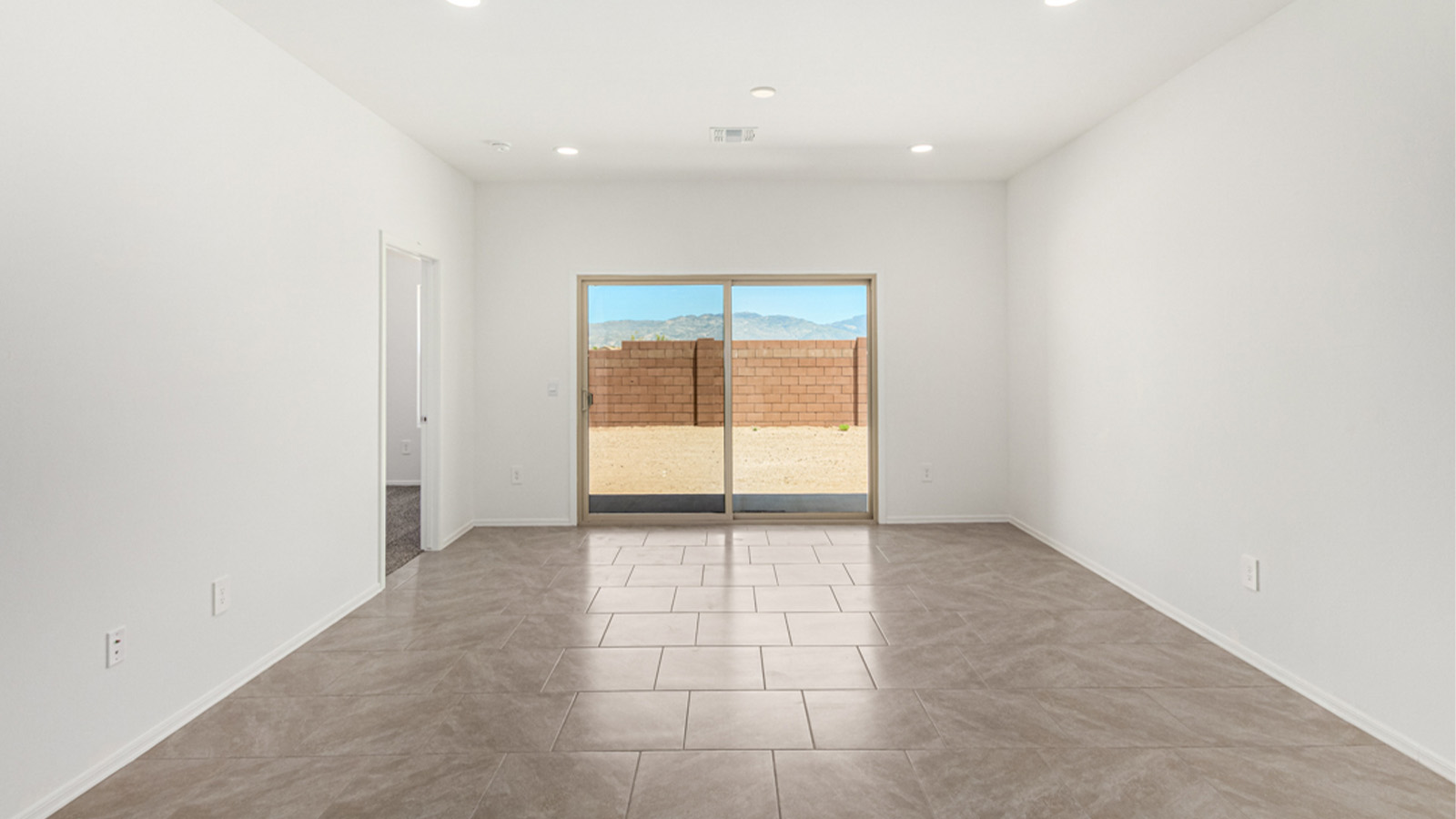 Welcome to The Amber at Hanson Ridge in Vail, Arizona – a beautifully crafted 1,331 sq. ft. single-story new home that offers modern living in a peaceful desert setting.  As you step through the inviting front porch, the thoughtfully designed entryway leads you into an open-concept living space that seamlessly connects the great room, dining area, and kitchen. This layout is ideal for both relaxing with family and entertaining guests. The kitchen, equipped with granite countertops, modern appliances, and a convenient pantry, is designed to meet your culinary needs while maintaining a stylish appeal.  The master suite, located at the rear of the home, offers a private retreat. The spacious bedroom is complemented by a large walk-in closet and an en-suite bathroom featuring dual vanities and a walk-in shower. This suite provides a serene space to unwind after a day of exploring the nearby Rincon Mountains or hiking through Saguaro National Park.  Two additional bedrooms are thoughtfully positioned to offer comfort and privacy, sharing a well-appointed full bathroom. The home also includes a utility room and direct access to a two-car garage, ensuring daily tasks are convenient and efficient.  Step outside to the covered patio, where you can enjoy Arizona’s beautiful weather and the incredible desert landscapes that Hanson Ridge has to offer. Whether you're enjoying a quiet morning coffee or hosting an evening gathering, this outdoor space is the perfect extension of your living area.  Living at Hanson Ridge means more than just having a beautiful home. The community offers a serene lifestyle with incredible mountain views and easy access to I-10 for convenient commutes to Tucson and surrounding areas. Hanson Ridge is designed with energy efficiency in mind, meeting DOE Zero Energy Ready Home standards to provide both comfort and sustainability.   Explore the charm and comfort of Hanson Ridge, where your new home awaits.