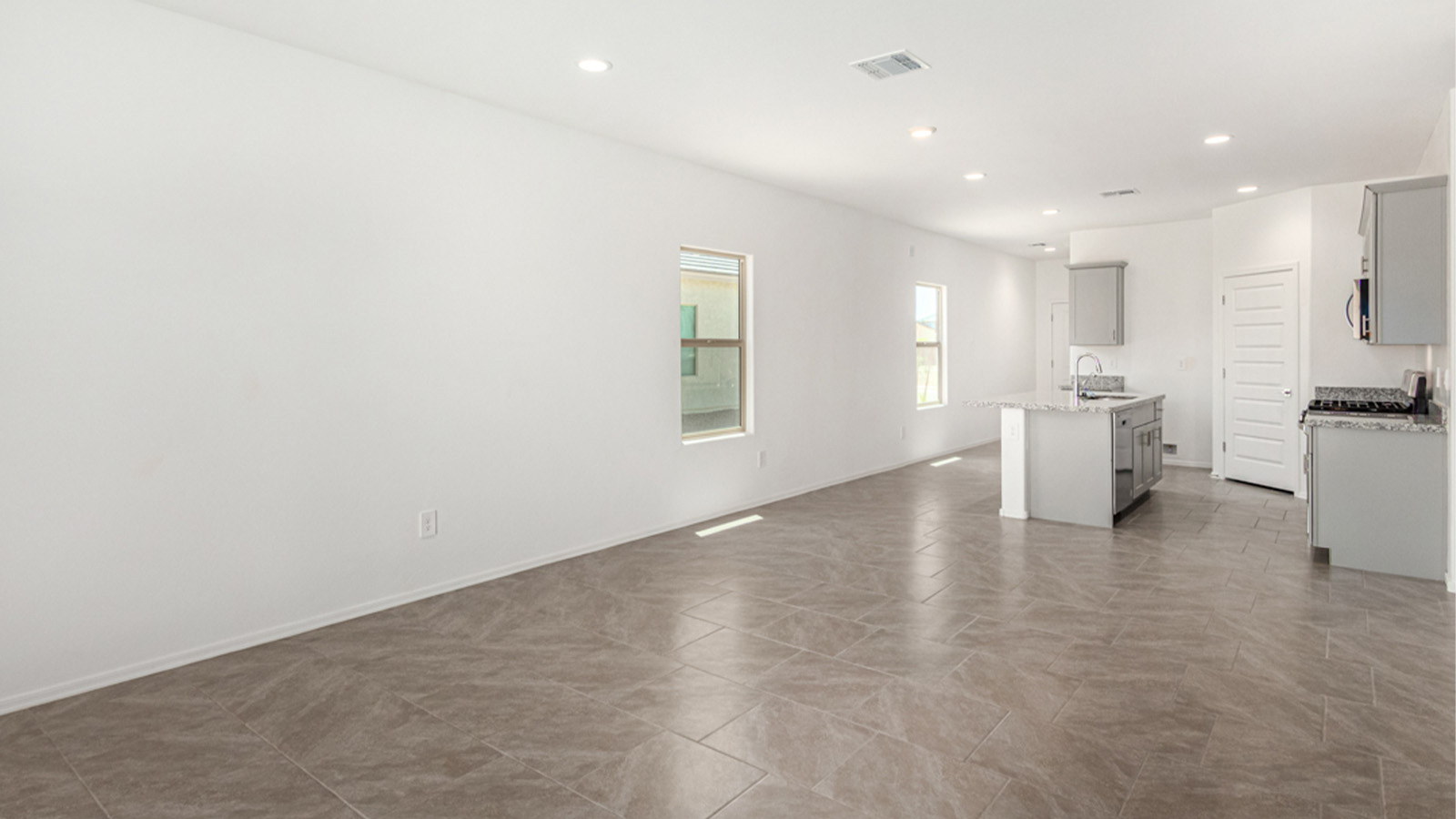 Welcome to The Amber at Hanson Ridge in Vail, Arizona – a beautifully crafted 1,331 sq. ft. single-story new home that offers modern living in a peaceful desert setting.  As you step through the inviting front porch, the thoughtfully designed entryway leads you into an open-concept living space that seamlessly connects the great room, dining area, and kitchen. This layout is ideal for both relaxing with family and entertaining guests. The kitchen, equipped with granite countertops, modern appliances, and a convenient pantry, is designed to meet your culinary needs while maintaining a stylish appeal.  The master suite, located at the rear of the home, offers a private retreat. The spacious bedroom is complemented by a large walk-in closet and an en-suite bathroom featuring dual vanities and a walk-in shower. This suite provides a serene space to unwind after a day of exploring the nearby Rincon Mountains or hiking through Saguaro National Park.  Two additional bedrooms are thoughtfully positioned to offer comfort and privacy, sharing a well-appointed full bathroom. The home also includes a utility room and direct access to a two-car garage, ensuring daily tasks are convenient and efficient.  Step outside to the covered patio, where you can enjoy Arizona’s beautiful weather and the incredible desert landscapes that Hanson Ridge has to offer. Whether you're enjoying a quiet morning coffee or hosting an evening gathering, this outdoor space is the perfect extension of your living area.  Living at Hanson Ridge means more than just having a beautiful home. The community offers a serene lifestyle with incredible mountain views and easy access to I-10 for convenient commutes to Tucson and surrounding areas. Hanson Ridge is designed with energy efficiency in mind, meeting DOE Zero Energy Ready Home standards to provide both comfort and sustainability.   Explore the charm and comfort of Hanson Ridge, where your new home awaits.