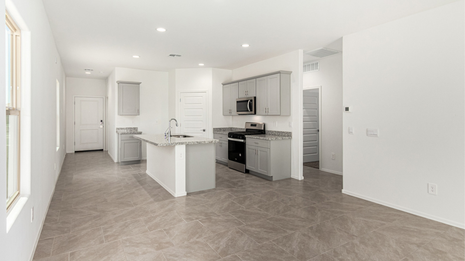 Welcome to The Amber at Hanson Ridge in Vail, Arizona – a beautifully crafted 1,331 sq. ft. single-story new home that offers modern living in a peaceful desert setting.  As you step through the inviting front porch, the thoughtfully designed entryway leads you into an open-concept living space that seamlessly connects the great room, dining area, and kitchen. This layout is ideal for both relaxing with family and entertaining guests. The kitchen, equipped with granite countertops, modern appliances, and a convenient pantry, is designed to meet your culinary needs while maintaining a stylish appeal.  The master suite, located at the rear of the home, offers a private retreat. The spacious bedroom is complemented by a large walk-in closet and an en-suite bathroom featuring dual vanities and a walk-in shower. This suite provides a serene space to unwind after a day of exploring the nearby Rincon Mountains or hiking through Saguaro National Park.  Two additional bedrooms are thoughtfully positioned to offer comfort and privacy, sharing a well-appointed full bathroom. The home also includes a utility room and direct access to a two-car garage, ensuring daily tasks are convenient and efficient.  Step outside to the covered patio, where you can enjoy Arizona’s beautiful weather and the incredible desert landscapes that Hanson Ridge has to offer. Whether you're enjoying a quiet morning coffee or hosting an evening gathering, this outdoor space is the perfect extension of your living area.  Living at Hanson Ridge means more than just having a beautiful home. The community offers a serene lifestyle with incredible mountain views and easy access to I-10 for convenient commutes to Tucson and surrounding areas. Hanson Ridge is designed with energy efficiency in mind, meeting DOE Zero Energy Ready Home standards to provide both comfort and sustainability.   Explore the charm and comfort of Hanson Ridge, where your new home awaits.