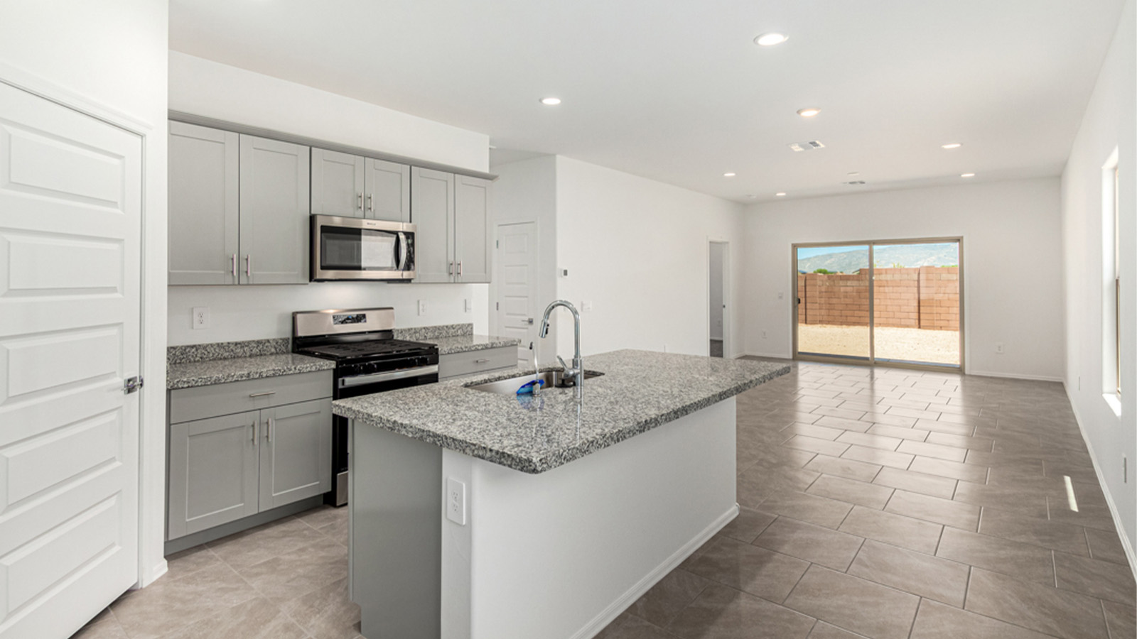 Welcome to The Amber at Hanson Ridge in Vail, Arizona – a beautifully crafted 1,331 sq. ft. single-story new home that offers modern living in a peaceful desert setting.  As you step through the inviting front porch, the thoughtfully designed entryway leads you into an open-concept living space that seamlessly connects the great room, dining area, and kitchen. This layout is ideal for both relaxing with family and entertaining guests. The kitchen, equipped with granite countertops, modern appliances, and a convenient pantry, is designed to meet your culinary needs while maintaining a stylish appeal.  The master suite, located at the rear of the home, offers a private retreat. The spacious bedroom is complemented by a large walk-in closet and an en-suite bathroom featuring dual vanities and a walk-in shower. This suite provides a serene space to unwind after a day of exploring the nearby Rincon Mountains or hiking through Saguaro National Park.  Two additional bedrooms are thoughtfully positioned to offer comfort and privacy, sharing a well-appointed full bathroom. The home also includes a utility room and direct access to a two-car garage, ensuring daily tasks are convenient and efficient.  Step outside to the covered patio, where you can enjoy Arizona’s beautiful weather and the incredible desert landscapes that Hanson Ridge has to offer. Whether you're enjoying a quiet morning coffee or hosting an evening gathering, this outdoor space is the perfect extension of your living area.  Living at Hanson Ridge means more than just having a beautiful home. The community offers a serene lifestyle with incredible mountain views and easy access to I-10 for convenient commutes to Tucson and surrounding areas. Hanson Ridge is designed with energy efficiency in mind, meeting DOE Zero Energy Ready Home standards to provide both comfort and sustainability.   Explore the charm and comfort of Hanson Ridge, where your new home awaits.