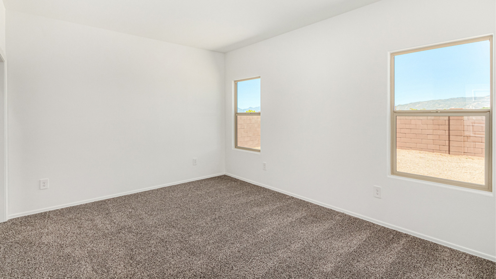 Welcome to The Amber at Hanson Ridge in Vail, Arizona – a beautifully crafted 1,331 sq. ft. single-story new home that offers modern living in a peaceful desert setting.  As you step through the inviting front porch, the thoughtfully designed entryway leads you into an open-concept living space that seamlessly connects the great room, dining area, and kitchen. This layout is ideal for both relaxing with family and entertaining guests. The kitchen, equipped with granite countertops, modern appliances, and a convenient pantry, is designed to meet your culinary needs while maintaining a stylish appeal.  The master suite, located at the rear of the home, offers a private retreat. The spacious bedroom is complemented by a large walk-in closet and an en-suite bathroom featuring dual vanities and a walk-in shower. This suite provides a serene space to unwind after a day of exploring the nearby Rincon Mountains or hiking through Saguaro National Park.  Two additional bedrooms are thoughtfully positioned to offer comfort and privacy, sharing a well-appointed full bathroom. The home also includes a utility room and direct access to a two-car garage, ensuring daily tasks are convenient and efficient.  Step outside to the covered patio, where you can enjoy Arizona’s beautiful weather and the incredible desert landscapes that Hanson Ridge has to offer. Whether you're enjoying a quiet morning coffee or hosting an evening gathering, this outdoor space is the perfect extension of your living area.  Living at Hanson Ridge means more than just having a beautiful home. The community offers a serene lifestyle with incredible mountain views and easy access to I-10 for convenient commutes to Tucson and surrounding areas. Hanson Ridge is designed with energy efficiency in mind, meeting DOE Zero Energy Ready Home standards to provide both comfort and sustainability.   Explore the charm and comfort of Hanson Ridge, where your new home awaits.