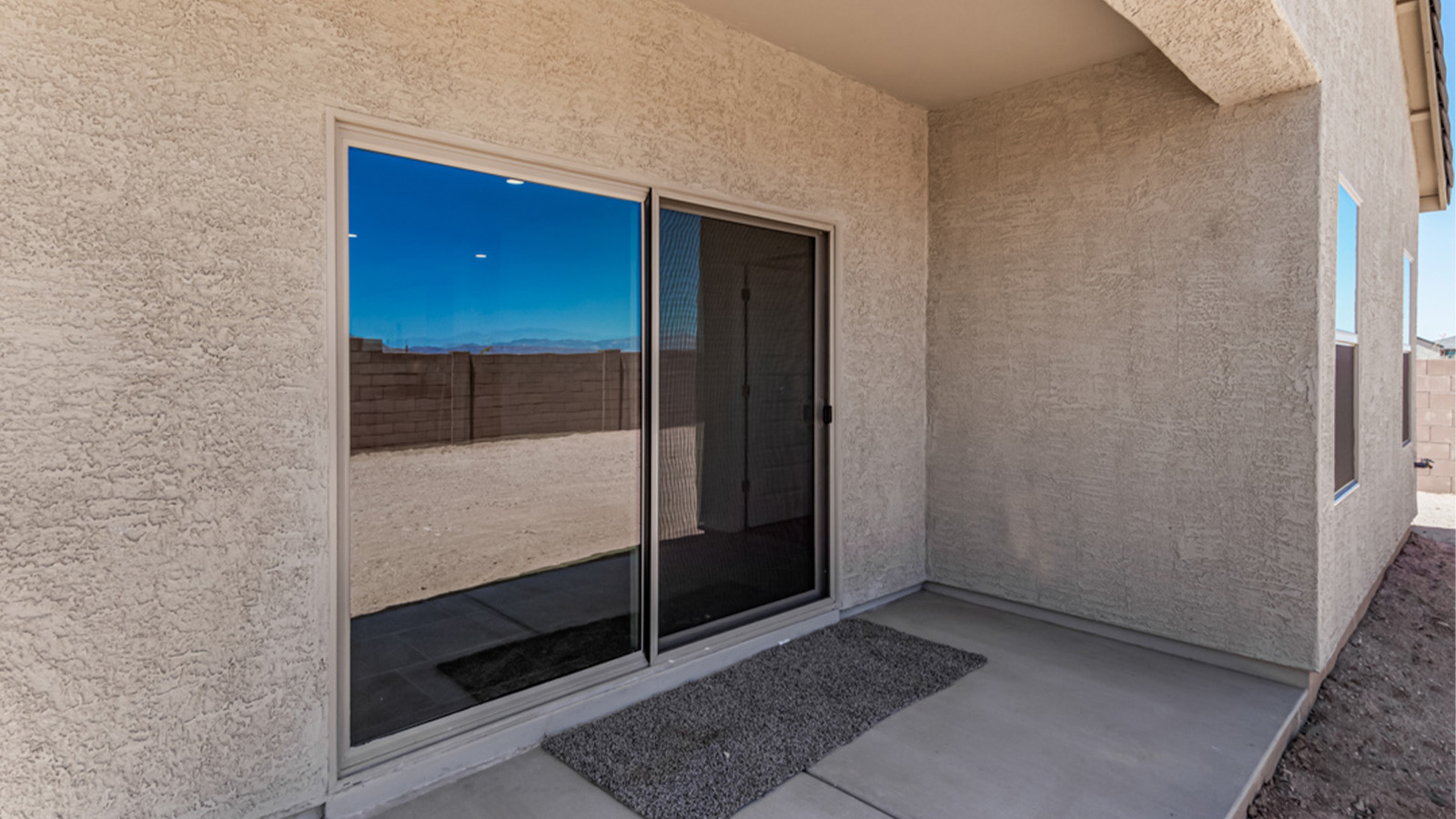 Welcome to The Amber at Hanson Ridge in Vail, Arizona – a beautifully crafted 1,331 sq. ft. single-story new home that offers modern living in a peaceful desert setting.  As you step through the inviting front porch, the thoughtfully designed entryway leads you into an open-concept living space that seamlessly connects the great room, dining area, and kitchen. This layout is ideal for both relaxing with family and entertaining guests. The kitchen, equipped with granite countertops, modern appliances, and a convenient pantry, is designed to meet your culinary needs while maintaining a stylish appeal.  The master suite, located at the rear of the home, offers a private retreat. The spacious bedroom is complemented by a large walk-in closet and an en-suite bathroom featuring dual vanities and a walk-in shower. This suite provides a serene space to unwind after a day of exploring the nearby Rincon Mountains or hiking through Saguaro National Park.  Two additional bedrooms are thoughtfully positioned to offer comfort and privacy, sharing a well-appointed full bathroom. The home also includes a utility room and direct access to a two-car garage, ensuring daily tasks are convenient and efficient.  Step outside to the covered patio, where you can enjoy Arizona’s beautiful weather and the incredible desert landscapes that Hanson Ridge has to offer. Whether you're enjoying a quiet morning coffee or hosting an evening gathering, this outdoor space is the perfect extension of your living area.  Living at Hanson Ridge means more than just having a beautiful home. The community offers a serene lifestyle with incredible mountain views and easy access to I-10 for convenient commutes to Tucson and surrounding areas. Hanson Ridge is designed with energy efficiency in mind, meeting DOE Zero Energy Ready Home standards to provide both comfort and sustainability.   Explore the charm and comfort of Hanson Ridge, where your new home awaits.