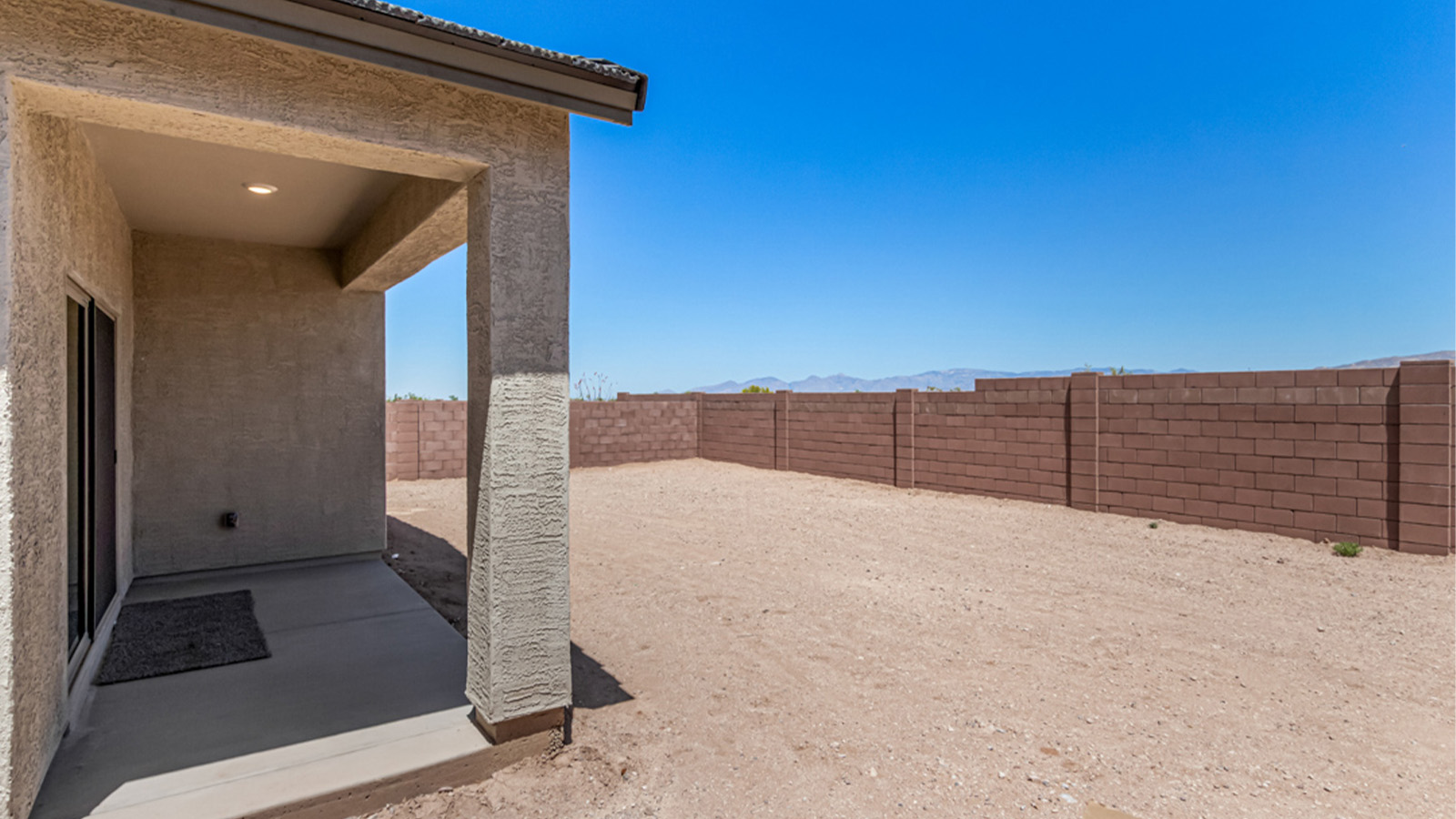 Welcome to The Amber at Hanson Ridge in Vail, Arizona – a beautifully crafted 1,331 sq. ft. single-story new home that offers modern living in a peaceful desert setting.  As you step through the inviting front porch, the thoughtfully designed entryway leads you into an open-concept living space that seamlessly connects the great room, dining area, and kitchen. This layout is ideal for both relaxing with family and entertaining guests. The kitchen, equipped with granite countertops, modern appliances, and a convenient pantry, is designed to meet your culinary needs while maintaining a stylish appeal.  The master suite, located at the rear of the home, offers a private retreat. The spacious bedroom is complemented by a large walk-in closet and an en-suite bathroom featuring dual vanities and a walk-in shower. This suite provides a serene space to unwind after a day of exploring the nearby Rincon Mountains or hiking through Saguaro National Park.  Two additional bedrooms are thoughtfully positioned to offer comfort and privacy, sharing a well-appointed full bathroom. The home also includes a utility room and direct access to a two-car garage, ensuring daily tasks are convenient and efficient.  Step outside to the covered patio, where you can enjoy Arizona’s beautiful weather and the incredible desert landscapes that Hanson Ridge has to offer. Whether you're enjoying a quiet morning coffee or hosting an evening gathering, this outdoor space is the perfect extension of your living area.  Living at Hanson Ridge means more than just having a beautiful home. The community offers a serene lifestyle with incredible mountain views and easy access to I-10 for convenient commutes to Tucson and surrounding areas. Hanson Ridge is designed with energy efficiency in mind, meeting DOE Zero Energy Ready Home standards to provide both comfort and sustainability.   Explore the charm and comfort of Hanson Ridge, where your new home awaits.