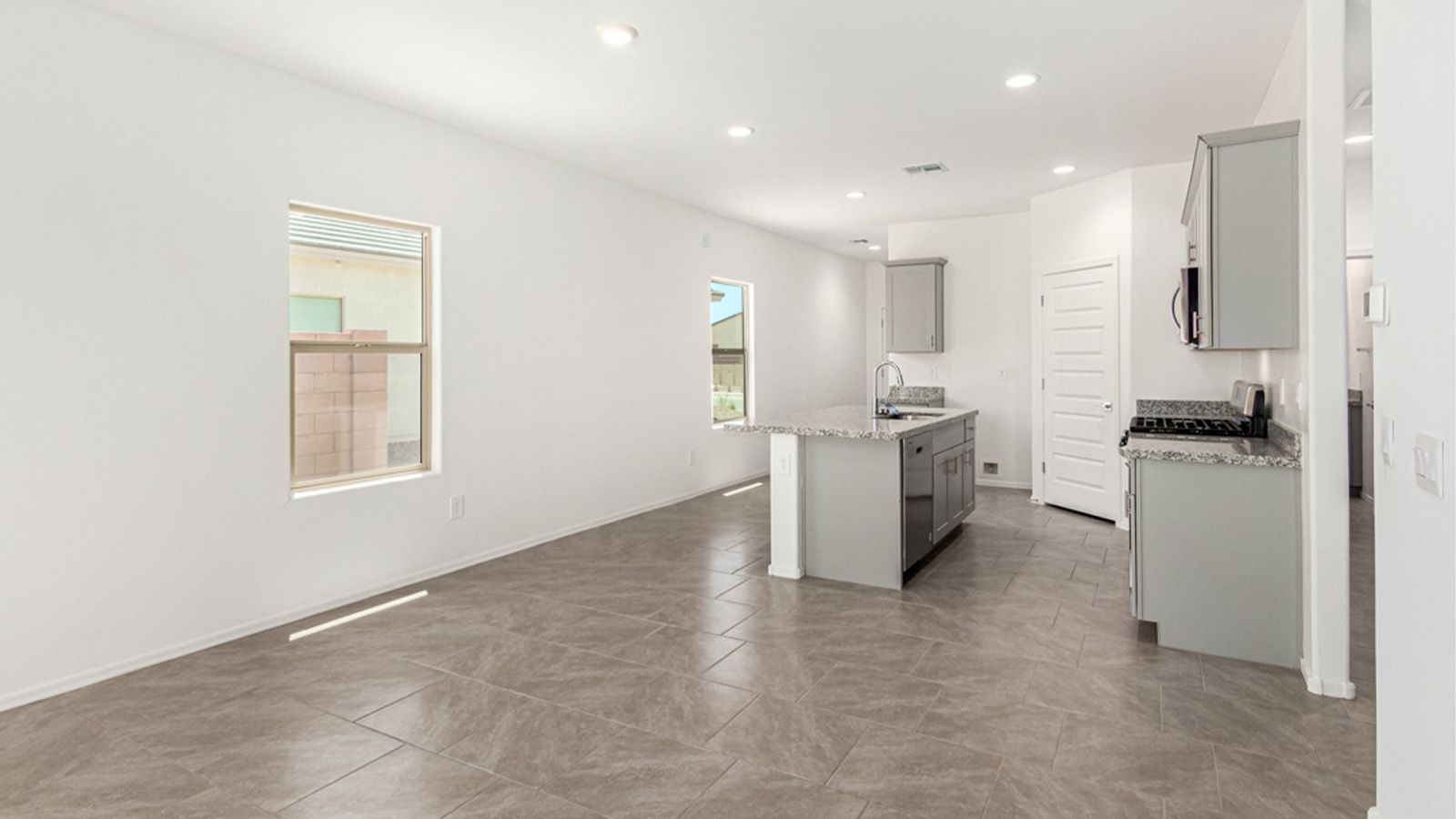 Welcome to The Amber at Hanson Ridge in Vail, Arizona – a beautifully crafted 1,331 sq. ft. single-story new home that offers modern living in a peaceful desert setting.  As you step through the inviting front porch, the thoughtfully designed entryway leads you into an open-concept living space that seamlessly connects the great room, dining area, and kitchen. This layout is ideal for both relaxing with family and entertaining guests. The kitchen, equipped with granite countertops, modern appliances, and a convenient pantry, is designed to meet your culinary needs while maintaining a stylish appeal.  The master suite, located at the rear of the home, offers a private retreat. The spacious bedroom is complemented by a large walk-in closet and an en-suite bathroom featuring dual vanities and a walk-in shower. This suite provides a serene space to unwind after a day of exploring the nearby Rincon Mountains or hiking through Saguaro National Park.  Two additional bedrooms are thoughtfully positioned to offer comfort and privacy, sharing a well-appointed full bathroom. The home also includes a utility room and direct access to a two-car garage, ensuring daily tasks are convenient and efficient.  Step outside to the covered patio, where you can enjoy Arizona’s beautiful weather and the incredible desert landscapes that Hanson Ridge has to offer. Whether you're enjoying a quiet morning coffee or hosting an evening gathering, this outdoor space is the perfect extension of your living area.  Living at Hanson Ridge means more than just having a beautiful home. The community offers a serene lifestyle with incredible mountain views and easy access to I-10 for convenient commutes to Tucson and surrounding areas. Hanson Ridge is designed with energy efficiency in mind, meeting DOE Zero Energy Ready Home standards to provide both comfort and sustainability.   Explore the charm and comfort of Hanson Ridge, where your new home awaits.