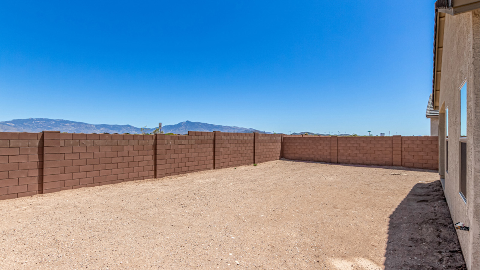 Welcome to The Amber at Hanson Ridge in Vail, Arizona – a beautifully crafted 1,331 sq. ft. single-story new home that offers modern living in a peaceful desert setting.  As you step through the inviting front porch, the thoughtfully designed entryway leads you into an open-concept living space that seamlessly connects the great room, dining area, and kitchen. This layout is ideal for both relaxing with family and entertaining guests. The kitchen, equipped with granite countertops, modern appliances, and a convenient pantry, is designed to meet your culinary needs while maintaining a stylish appeal.  The master suite, located at the rear of the home, offers a private retreat. The spacious bedroom is complemented by a large walk-in closet and an en-suite bathroom featuring dual vanities and a walk-in shower. This suite provides a serene space to unwind after a day of exploring the nearby Rincon Mountains or hiking through Saguaro National Park.  Two additional bedrooms are thoughtfully positioned to offer comfort and privacy, sharing a well-appointed full bathroom. The home also includes a utility room and direct access to a two-car garage, ensuring daily tasks are convenient and efficient.  Step outside to the covered patio, where you can enjoy Arizona’s beautiful weather and the incredible desert landscapes that Hanson Ridge has to offer. Whether you're enjoying a quiet morning coffee or hosting an evening gathering, this outdoor space is the perfect extension of your living area.  Living at Hanson Ridge means more than just having a beautiful home. The community offers a serene lifestyle with incredible mountain views and easy access to I-10 for convenient commutes to Tucson and surrounding areas. Hanson Ridge is designed with energy efficiency in mind, meeting DOE Zero Energy Ready Home standards to provide both comfort and sustainability.   Explore the charm and comfort of Hanson Ridge, where your new home awaits.