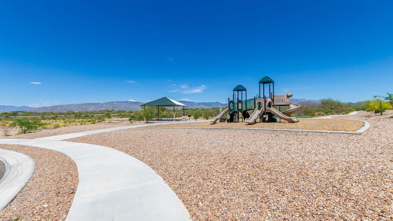 Step into The Diana at Hanson Ridge in Vail, Arizona – a thoughtfully crafted 1,558 sq. ft. single-story new home designed to offer a perfect harmony of comfort and desert elegance.  As you enter through the inviting front porch, you're welcomed into a bright and airy living space that flows seamlessly into the great room, dining area, and kitchen. This open-concept design is perfect for both casual family living and entertaining. The kitchen, with its granite countertops, modern appliances, and a convenient pantry, is both stylish and functional, making meal preparation a breeze.  The master suite, located at the rear of the home, provides a private retreat with a spacious bedroom, a large walk-in closet, and an en-suite bathroom featuring dual vanities and a walk-in shower. This suite offers a peaceful escape, ideal for relaxation after a day of enjoying the natural beauty surrounding Hanson Ridge.  Two additional bedrooms are thoughtfully placed to provide privacy and comfort, sharing a well-appointed full bathroom. The home also includes a utility room for added convenience and direct access to a two-car garage, making daily tasks efficient and easy.  Step outside from the great room to the covered patio, where you can enjoy Arizona’s beautiful weather year-round. Whether you're savoring a quiet morning or hosting an evening gathering, this outdoor space extends your living area into the tranquil surroundings of Hanson Ridge.  Living at Hanson Ridge means more than just having a beautiful home. The community offers a peaceful lifestyle with incredible desert landscapes, mountain views, and easy access to I-10 for convenient commutes to Tucson and surrounding areas. Designed with energy efficiency in mind, The Diana at Hanson Ridge meets DOE Zero Energy Ready Home standards, ensuring sustainability and long-term savings.  Experience the charm and comfort of The Diana at Hanson Ridge, where modern convenience meets the beauty of Arizona’s desert landscape.