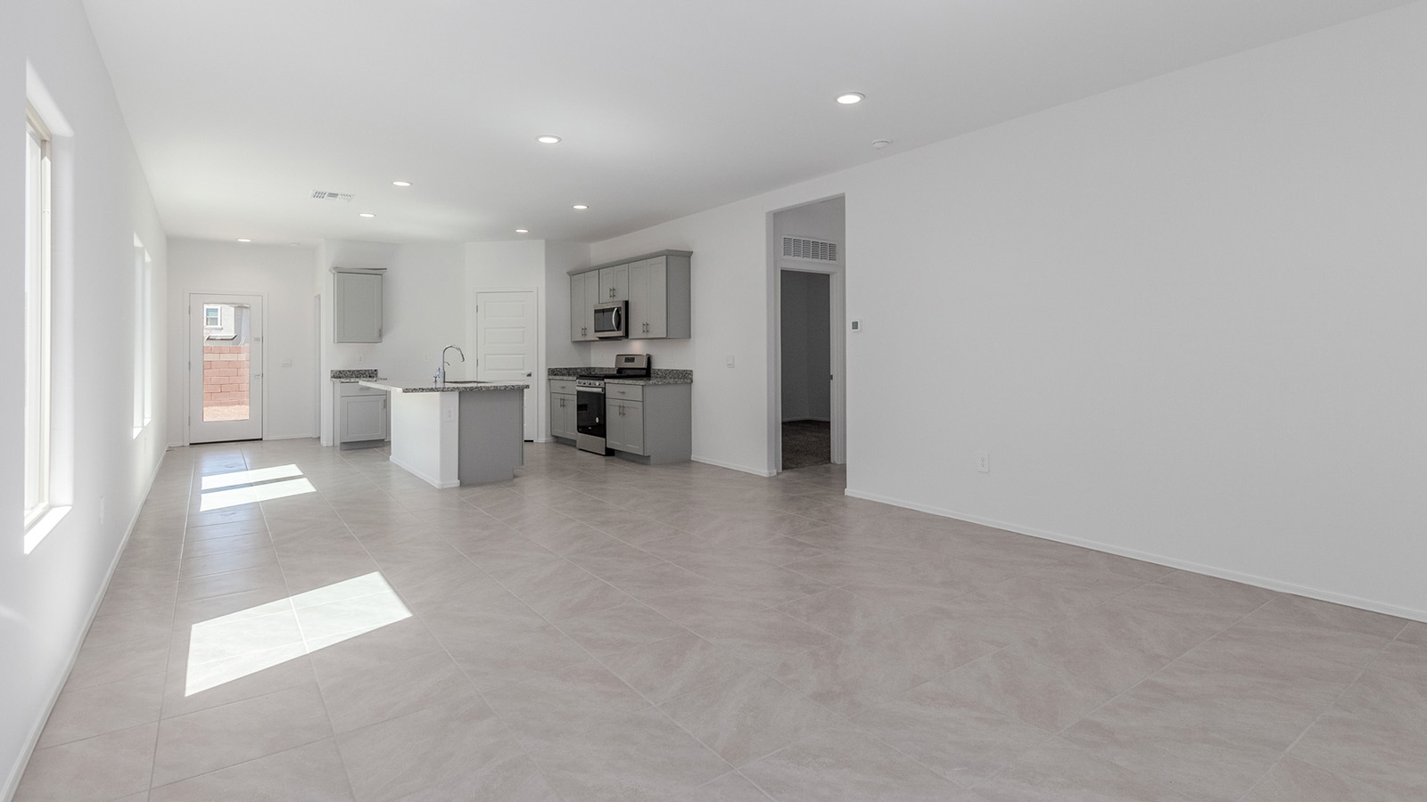 Step into The Diana at Hanson Ridge in Vail, Arizona – a thoughtfully crafted 1,558 sq. ft. single-story new home designed to offer a perfect harmony of comfort and desert elegance.  As you enter through the inviting front porch, you're welcomed into a bright and airy living space that flows seamlessly into the great room, dining area, and kitchen. This open-concept design is perfect for both casual family living and entertaining. The kitchen, with its granite countertops, modern appliances, and a convenient pantry, is both stylish and functional, making meal preparation a breeze.  The master suite, located at the rear of the home, provides a private retreat with a spacious bedroom, a large walk-in closet, and an en-suite bathroom featuring dual vanities and a walk-in shower. This suite offers a peaceful escape, ideal for relaxation after a day of enjoying the natural beauty surrounding Hanson Ridge.  Two additional bedrooms are thoughtfully placed to provide privacy and comfort, sharing a well-appointed full bathroom. The home also includes a utility room for added convenience and direct access to a two-car garage, making daily tasks efficient and easy.  Step outside from the great room to the covered patio, where you can enjoy Arizona’s beautiful weather year-round. Whether you're savoring a quiet morning or hosting an evening gathering, this outdoor space extends your living area into the tranquil surroundings of Hanson Ridge.  Living at Hanson Ridge means more than just having a beautiful home. The community offers a peaceful lifestyle with incredible desert landscapes, mountain views, and easy access to I-10 for convenient commutes to Tucson and surrounding areas. Designed with energy efficiency in mind, The Diana at Hanson Ridge meets DOE Zero Energy Ready Home standards, ensuring sustainability and long-term savings.  Experience the charm and comfort of The Diana at Hanson Ridge, where modern convenience meets the beauty of Arizona’s desert landscape.