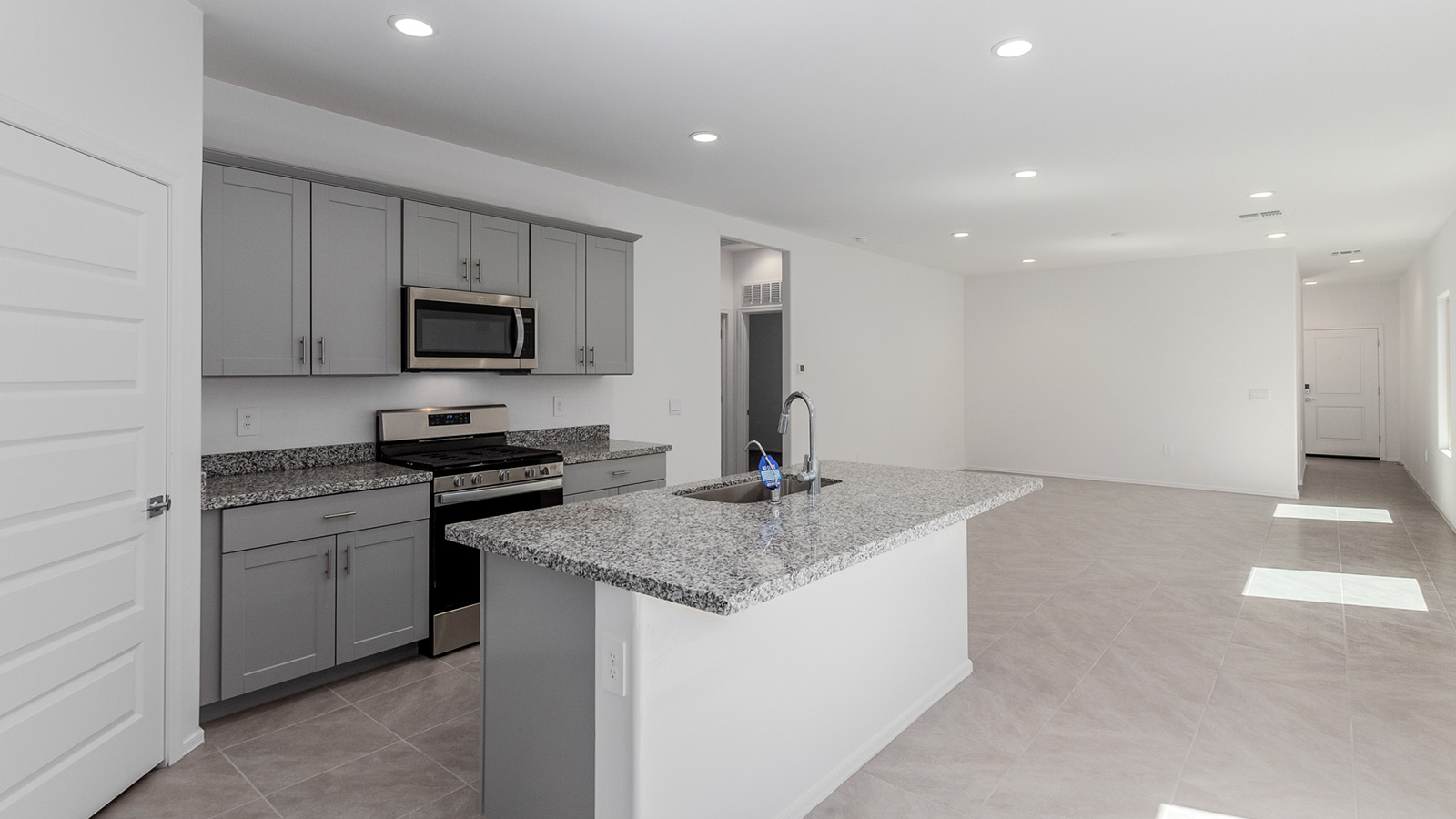 Step into The Diana at Hanson Ridge in Vail, Arizona – a thoughtfully crafted 1,558 sq. ft. single-story new home designed to offer a perfect harmony of comfort and desert elegance.  As you enter through the inviting front porch, you're welcomed into a bright and airy living space that flows seamlessly into the great room, dining area, and kitchen. This open-concept design is perfect for both casual family living and entertaining. The kitchen, with its granite countertops, modern appliances, and a convenient pantry, is both stylish and functional, making meal preparation a breeze.  The master suite, located at the rear of the home, provides a private retreat with a spacious bedroom, a large walk-in closet, and an en-suite bathroom featuring dual vanities and a walk-in shower. This suite offers a peaceful escape, ideal for relaxation after a day of enjoying the natural beauty surrounding Hanson Ridge.  Two additional bedrooms are thoughtfully placed to provide privacy and comfort, sharing a well-appointed full bathroom. The home also includes a utility room for added convenience and direct access to a two-car garage, making daily tasks efficient and easy.  Step outside from the great room to the covered patio, where you can enjoy Arizona’s beautiful weather year-round. Whether you're savoring a quiet morning or hosting an evening gathering, this outdoor space extends your living area into the tranquil surroundings of Hanson Ridge.  Living at Hanson Ridge means more than just having a beautiful home. The community offers a peaceful lifestyle with incredible desert landscapes, mountain views, and easy access to I-10 for convenient commutes to Tucson and surrounding areas. Designed with energy efficiency in mind, The Diana at Hanson Ridge meets DOE Zero Energy Ready Home standards, ensuring sustainability and long-term savings.  Experience the charm and comfort of The Diana at Hanson Ridge, where modern convenience meets the beauty of Arizona’s desert landscape.