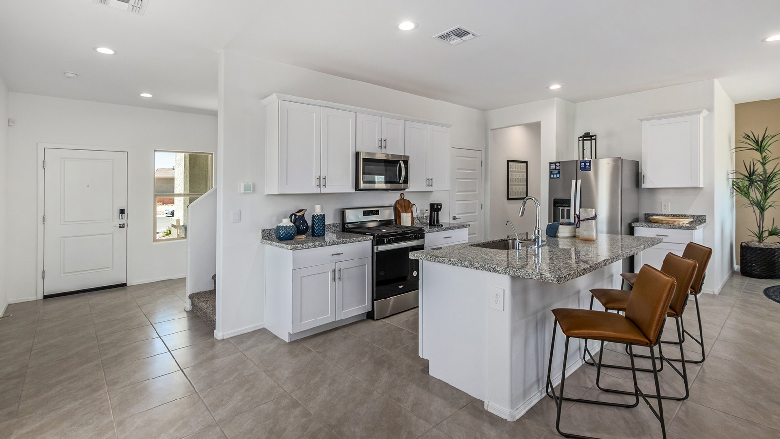 Discover The Kate at Hanson Ridge in Vail, Arizona – a beautifully designed 2,264 sq. ft. two-story floor plan that seamlessly blends functionality with style, offering a perfect retreat within the stunning desert landscape.  As you step through the front porch, you're greeted by a spacious entryway that leads directly into the heart of the home. The main floor is laid out to accommodate both everyday living and special occasions. The expansive great room opens into the dining area and the kitchen, creating a central hub for gatherings. The kitchen features quartz countertops, modern appliances, and a large walk-in pantry.  The covered patio is just off the dining area extends your living space outdoors, perfect for enjoying the beautiful Arizona weather year-round.  Upstairs, The Kate offers a private sanctuary with four well-appointed bedrooms. The primary suite is a true sanctuary, featuring a spacious bedroom, a large walk-in closet, and an en-suite bathroom. The upper level also includes three additional bedrooms, each with ample closet space, and a full bathroom conveniently located near the laundry room. A versatile loft provides additional space for relaxation, hobbies, or work, making this home ideal for growing families.  Living at Hanson Ridge means enjoying the best of both worlds – a peaceful, scenic environment with easy access to modern conveniences. The community offers parks, walking paths, and playgrounds, making it a perfect setting for families. Hanson Ridge homes, including The Kate, are built with energy efficiency in mind, meeting DOE Zero Energy Ready Home standards. This means you can enjoy a sustainable lifestyle with lower utility costs, featuring advanced energy-saving technologies and smart home features.  *Images shown are for reference only. They depict The Kate model and may not represent the actual home.