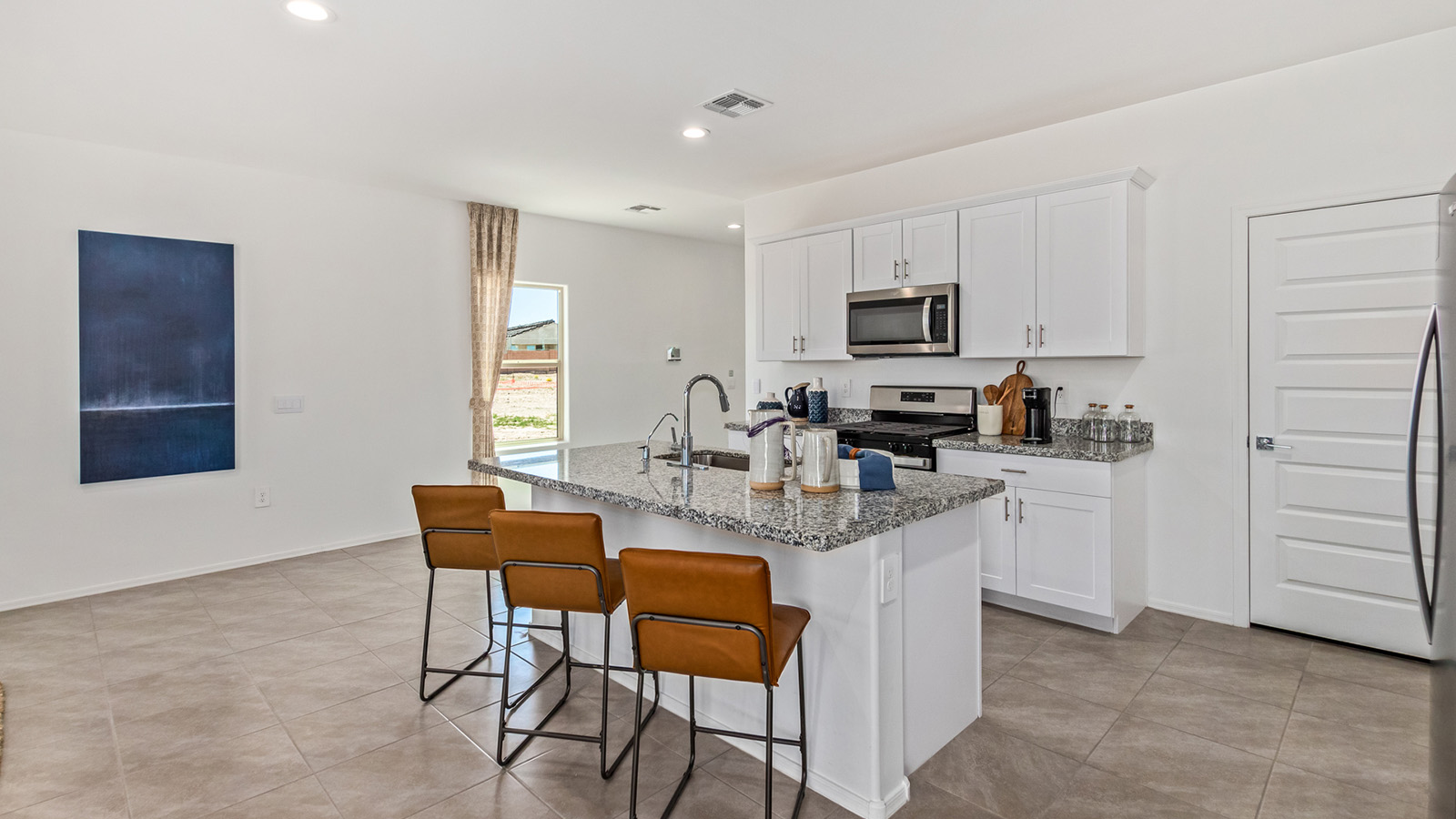 Discover The Kate at Hanson Ridge in Vail, Arizona – a beautifully designed 2,264 sq. ft. two-story floor plan that seamlessly blends functionality with style, offering a perfect retreat within the stunning desert landscape.  As you step through the front porch, you're greeted by a spacious entryway that leads directly into the heart of the home. The main floor is laid out to accommodate both everyday living and special occasions. The expansive great room opens into the dining area and the kitchen, creating a central hub for gatherings. The kitchen features quartz countertops, modern appliances, and a large walk-in pantry.  The covered patio is just off the dining area extends your living space outdoors, perfect for enjoying the beautiful Arizona weather year-round.  Upstairs, The Kate offers a private sanctuary with four well-appointed bedrooms. The primary suite is a true sanctuary, featuring a spacious bedroom, a large walk-in closet, and an en-suite bathroom. The upper level also includes three additional bedrooms, each with ample closet space, and a full bathroom conveniently located near the laundry room. A versatile loft provides additional space for relaxation, hobbies, or work, making this home ideal for growing families.  Living at Hanson Ridge means enjoying the best of both worlds – a peaceful, scenic environment with easy access to modern conveniences. The community offers parks, walking paths, and playgrounds, making it a perfect setting for families. Hanson Ridge homes, including The Kate, are built with energy efficiency in mind, meeting DOE Zero Energy Ready Home standards. This means you can enjoy a sustainable lifestyle with lower utility costs, featuring advanced energy-saving technologies and smart home features.  *Images shown are for reference only. They depict The Kate model and may not represent the actual home.