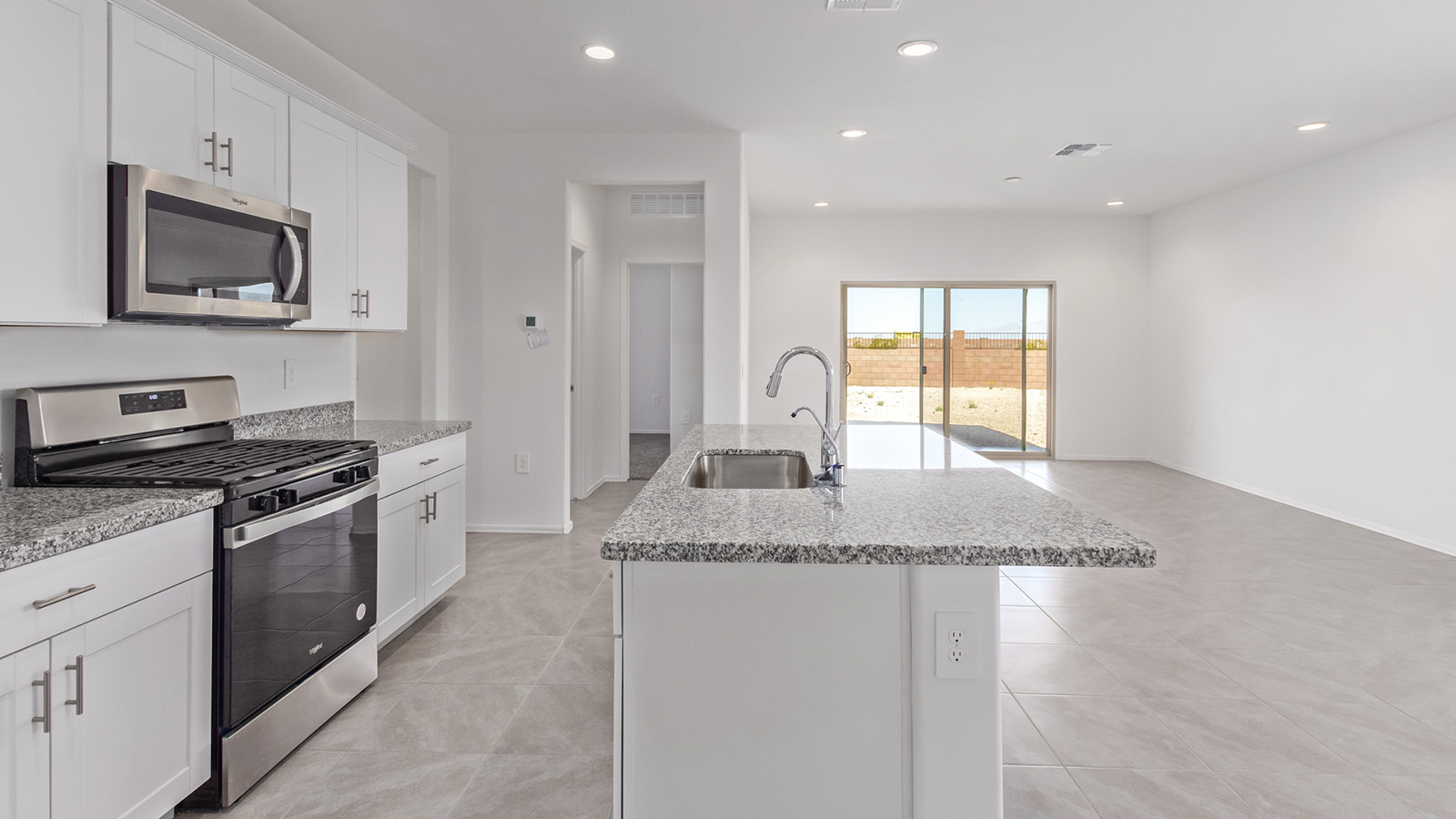 Welcome to The Madison at Hanson Ridge in Vail, Arizona – a beautifully designed 2,522 sq. ft. two-story floor plan designed for families seeking both luxury and functionality.  As you step through the inviting front porch, you're greeted by a thoughtfully designed entryway that leads into the heart of the home. The main level features a spacious great room that flows effortlessly into the dining area and the kitchen, making it an ideal space for entertaining and family gatherings. The kitchen is equipped with elegant quartz countertops, a large central island with a breakfast bar, modern appliances, and a pantry that provides ample storage, ensuring that the kitchen is as functional as it is stylish.  The main floor also includes a bedroom with easy access to a full bathroom, making it a perfect guest suite or a private home office. The convenient bathroom and direct access to the two-car garage enhance the home’s functionality, while the nearby utility room adds a layer of practicality to daily living.  Heading upstairs, you��ll find the family’s private quarters. The primary suite is a true retreat, featuring a generously sized bedroom, a large walk-in closet, and an en-suite bathroom. The upper level also includes three additional bedrooms, a full bathroom, and a versatile loft area that can be tailored to fit your lifestyle, whether as a playroom, home office, or additional living space.  Back downstairs, step outside from the great room to the covered patio, where you can enjoy Tucson’s stunning weather year-round. Whether you’re hosting an outdoor gathering or simply relaxing after a long day, this space extends your living area and enhances the home’s inviting ambiance.  Designed with energy efficiency in mind, The Madison at Hanson Ridge is a DOE Zero Energy Ready Home, ensuring sustainability, comfort, and long-term savings.  *Images shown are for reference only. They depict The Madison spec home and may not represent the actual home.