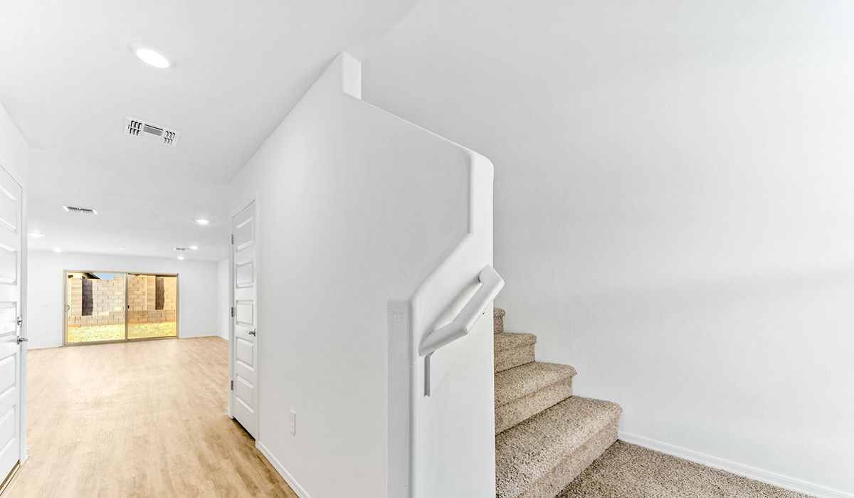 Welcome to The Madison at Hanson Ridge in Vail, Arizona – a beautifully designed 2,522 sq. ft. two-story floor plan designed for families seeking both luxury and functionality.  As you step through the inviting front porch, you're greeted by a thoughtfully designed entryway that leads into the heart of the home. The main level features a spacious great room that flows effortlessly into the dining area and the kitchen, making it an ideal space for entertaining and family gatherings. The kitchen is equipped with elegant quartz countertops, a large central island with a breakfast bar, modern appliances, and a pantry that provides ample storage, ensuring that the kitchen is as functional as it is stylish.  The main floor also includes a bedroom with easy access to a full bathroom, making it a perfect guest suite or a private home office. The convenient bathroom and direct access to the two-car garage enhance the home’s functionality, while the nearby utility room adds a layer of practicality to daily living.  Heading upstairs, you’ll find the family’s private quarters. The primary suite is a true retreat, featuring a generously sized bedroom, a large walk-in closet, and an en-suite bathroom. The upper level also includes three additional bedrooms, a full bathroom, and a versatile loft area that can be tailored to fit your lifestyle, whether as a playroom, home office, or additional living space.  Back downstairs, step outside from the great room to the covered patio, where you can enjoy Tucson’s stunning weather year-round. Whether you’re hosting an outdoor gathering or simply relaxing after a long day, this space extends your living area and enhances the home’s inviting ambiance.  Designed with energy efficiency in mind, The Madison at Hanson Ridge is a DOE Zero Energy Ready Home, ensuring sustainability, comfort, and long-term savings.