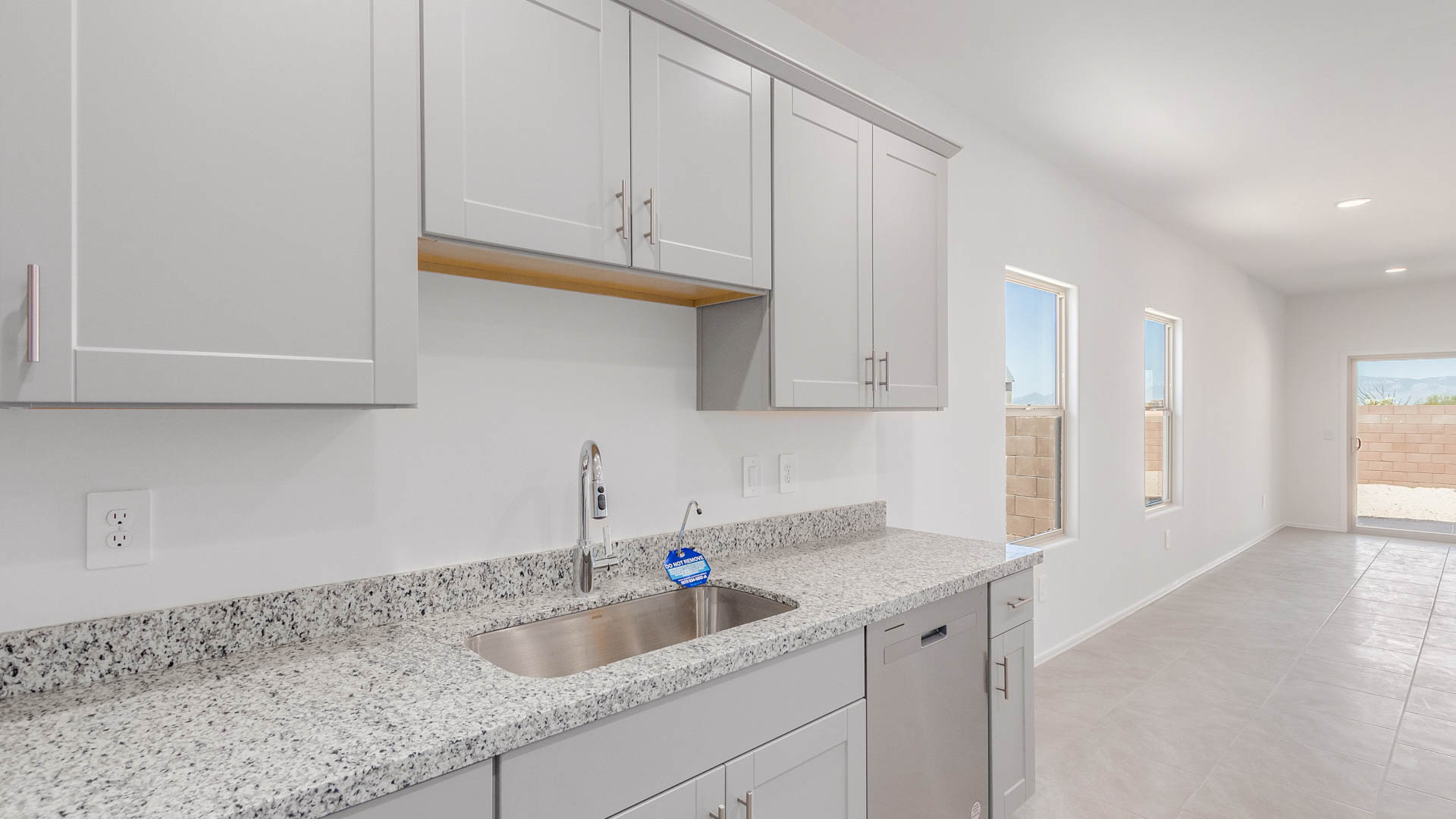 Discover the Parker at Hanson Ridge in Vail, Arizona - a beautifully designed single-story home that perfectly balances comfort and elegance. This thoughtfully crafted 1,909 square foot floor plan features five bedrooms and 3 full size bathrooms. Whether you're looking for extra space or a more open layout, the Parker is designed to suit your lifestyle with style and functionality in every detail.  As you enter through the inviting front porch, you're welcomed into a bright and airy living space that flows seamlessly into the great room, dining area, and kitchen. This open-concept design is perfect for both family gatherings and entertaining. The kitchen features Quartz countertops, Shaker Style Cabinetry, modern appliances, and a convenient pantry, making meal preparation a breeze.  The primary suite, located at the rear of the home, providing a private retreat with a spacious a large walk-in closet, and en-suite bathroom featuring dual vanities and a walk-in shower. The Parker floor plan also includes a utility room and two-car garage.  Living at Hanson Ridge means more than just having a beautiful home. The community offers a peaceful lifestyle with incredible desert landscapes, mountain views, and easy access to I-10 for convenient commutes to Tucson and surrounding areas. Designed with energy efficiency in mind, The Dalea at Hanson Ridge meets Zero Energy Ready Home standards, ensuring sustainability and long-term savings.  Experience the charm and comfort of The Parker at Hanson Ridge, where modern convenience meets the beauty of Arizona’s desert landscape.