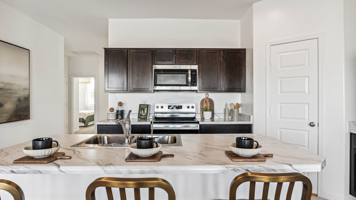 Step into The Denton at Hanson Ridge in Vail, Arizona - a thoughtfully crafted 1,590 sq. ft. single-story new home designed to offer a perfect harmony of comfort and desert elegance.  As you enter through the inviting front porch, you're welcomed into a bright and airy entry space that flows seamlessly into the great room, dining area, and kitchen. This open-concept design is perfect for both casual family living and entertaining. The kitchen, with its Quartz countertops, modern appliances, and a convenient pantry, is both stylish and functional, making meal preparation a breeze.  The primary suite, located at the rear of the home, provides a private retreat with a spacious bedroom, a large walk-in closet, and an en-suite bathroom featuring large vanity with sink or double optional sink, walk-in shower, and walk-in closet.  Whether you’re planning to create a dream outdoor oasis or simply enjoy the natural surroundings, this space offers endless possibilities. Built with modern living in mind, The Denton floor plan includes D.R. Horton’s Home is Connected® Smart Home package, featuring a smart thermostat, video doorbell, keyless entry, and a Wi-Fi enabled garage door opener. Energy efficiency is also a priority, with spray foam insulation and designs that meet the DOE Zero Energy Ready Home standards, ensuring long-term savings and environmental benefits.  Located within the serene Hanson Ridge community, residents of The Denton enjoy the luxury of space combined with easy access to urban amenities. Come home to The Denton, where comfort, style, and the beauty of Arizona living come together in perfect harmony.  *Images shown are for reference only. They depict The Denton model home and may not represent the actual home.