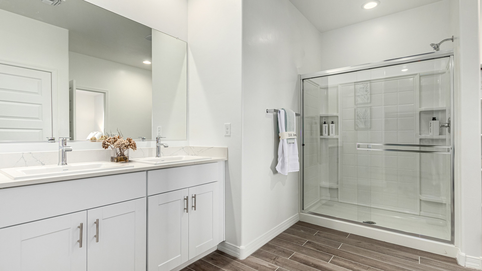 Step into The Cali at Hanson Ridge in Vail, Arizona - a thoughtfully crafted 1,823 sq. ft. single-story new home designed to offer a perfect harmony of comfort and desert elegance. As you enter through the inviting front porch, you're welcomed into a bright and airy living space that flows seamlessly into the great room, dining area, and kitchen. This open-concept design is perfect for both casual family living and entertaining. The kitchen, with its Quartz countertops, modern appliances, and a convenient pantry, is both stylish and functional, making meal preparation a breeze. The primary suite, located at the rear of the home, provides a private retreat with a spacious bedroom, a large walk-in closet, and an en-suite bathroom featuring dual vanities and a walk-in shower.  Whether you’re planning to create a dream outdoor oasis or simply enjoy the natural surroundings, this space offers endless possibilities. Built with modern living in mind, The Cali includes D.R. Horton’s Home is Connected® Smart Home package, featuring a smart thermostat, video doorbell, keyless entry, and a Wi-Fi enabled garage door opener. Energy efficiency is also a priority, with spray foam insulation and designs that meet the DOE Zero Energy Ready Home standards, ensuring long-term savings and environmental benefits.  Located within the serene Hanson Ridge community, residents of The Cali enjoy the luxury of space combined with easy access to urban amenities. Come home to The Cali, where comfort, style, and the beauty of Arizona living come together in perfect harmony.  *Images shown are for reference only. They depict the sales model home and may not represent the actual home.